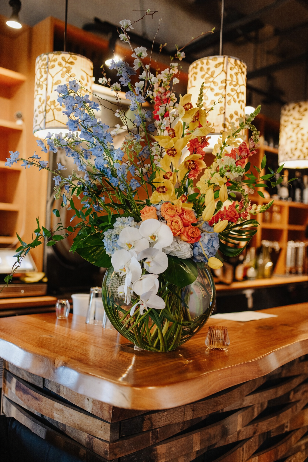 Elegant floral arrangement in a rustic bar.png
