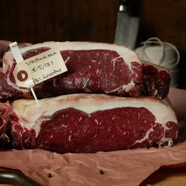 Striploin - Grass-fed beef, naturally raised, finished on potatoes and dry aged in house. Cut to order.