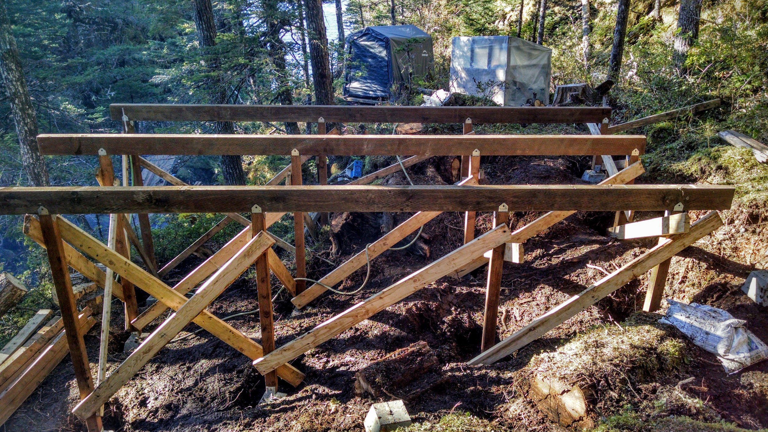  September 24, 2015: The first three beams of the first yurt platform are up. This is HUGE progress in addition to the fact that the sun is shining! 