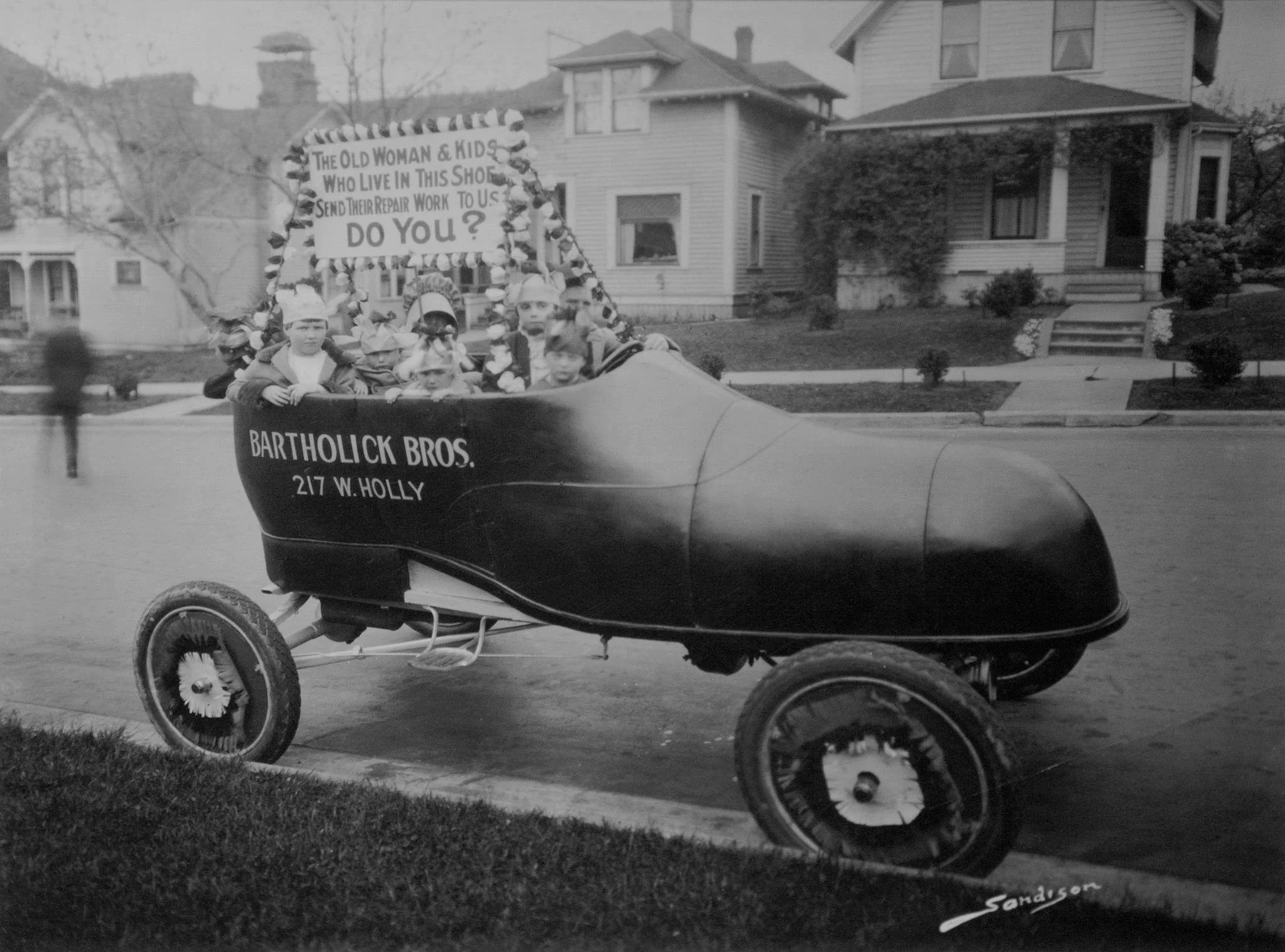 George Bartholick, age 4, (to the right of the steering wheel) in a Bellingham parade.