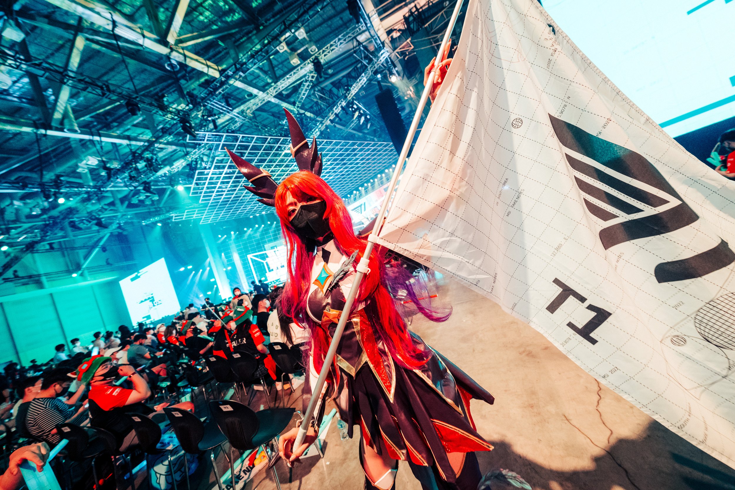 Cosplayer holding up T1 Flag