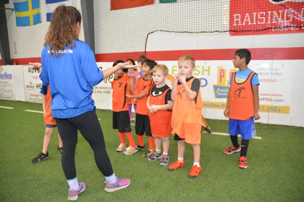 Coach Instructs A Group of Soccer Cubs Students