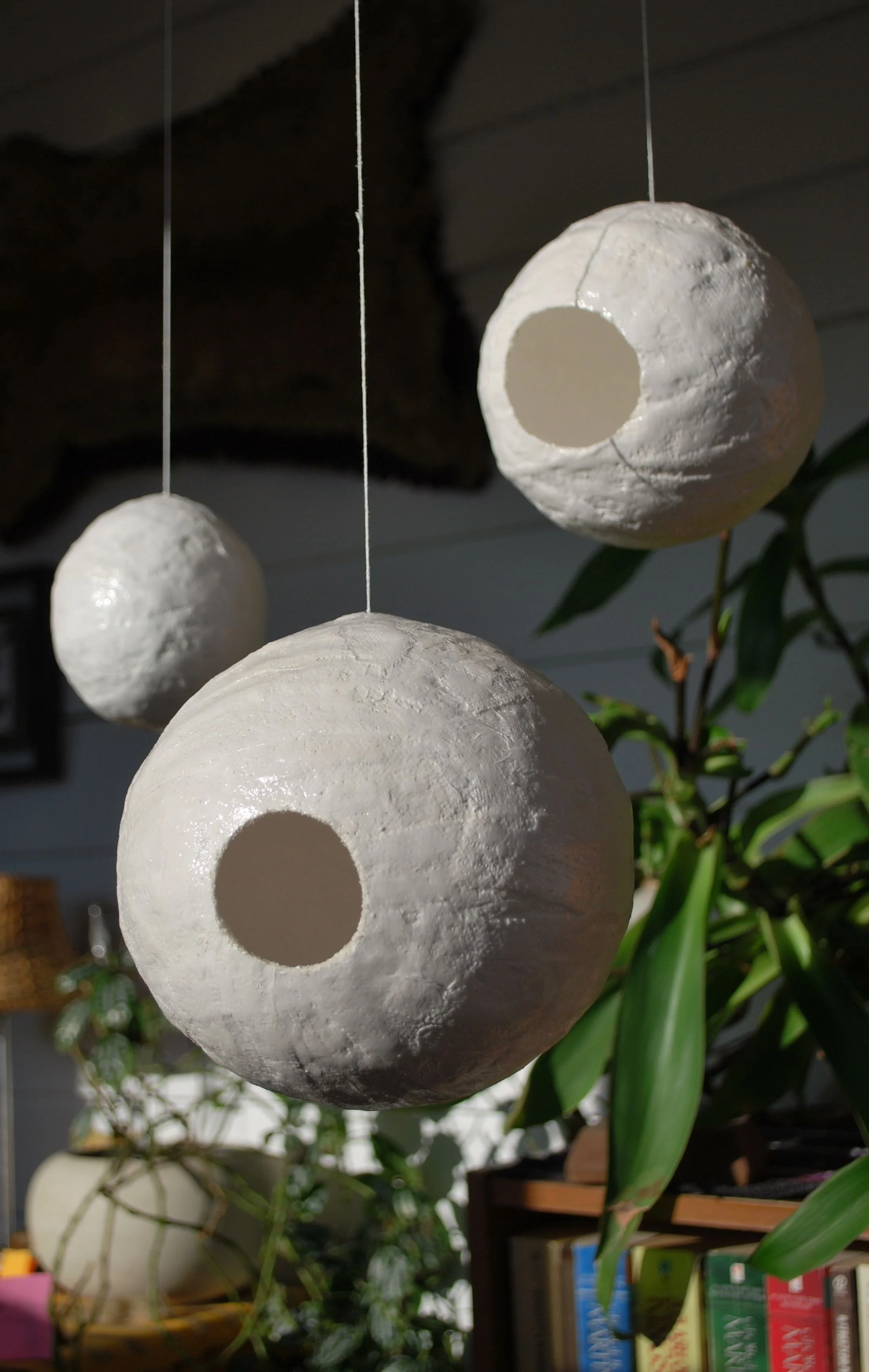 Ball Series includes 100 total- Untitled, left and three images below, 3" to 7" diameter, various opening sizes, 2009, plaster cloth & mod podge