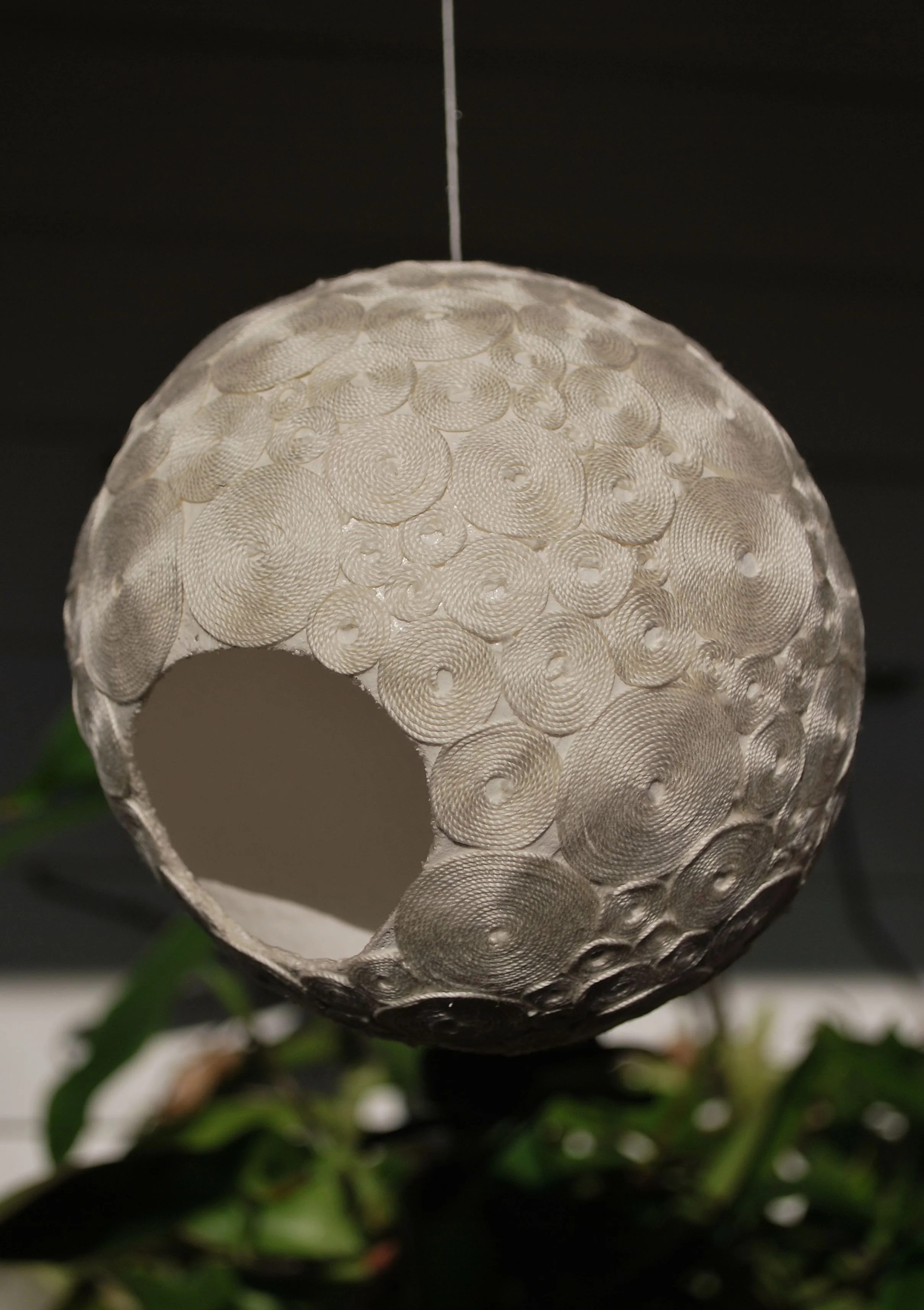 spiral ball #2, left and one image below, 16" circumference, 1 1/2" opening, Winter 2013, crochet thread, plaster cloth, mod podge & elmers glue