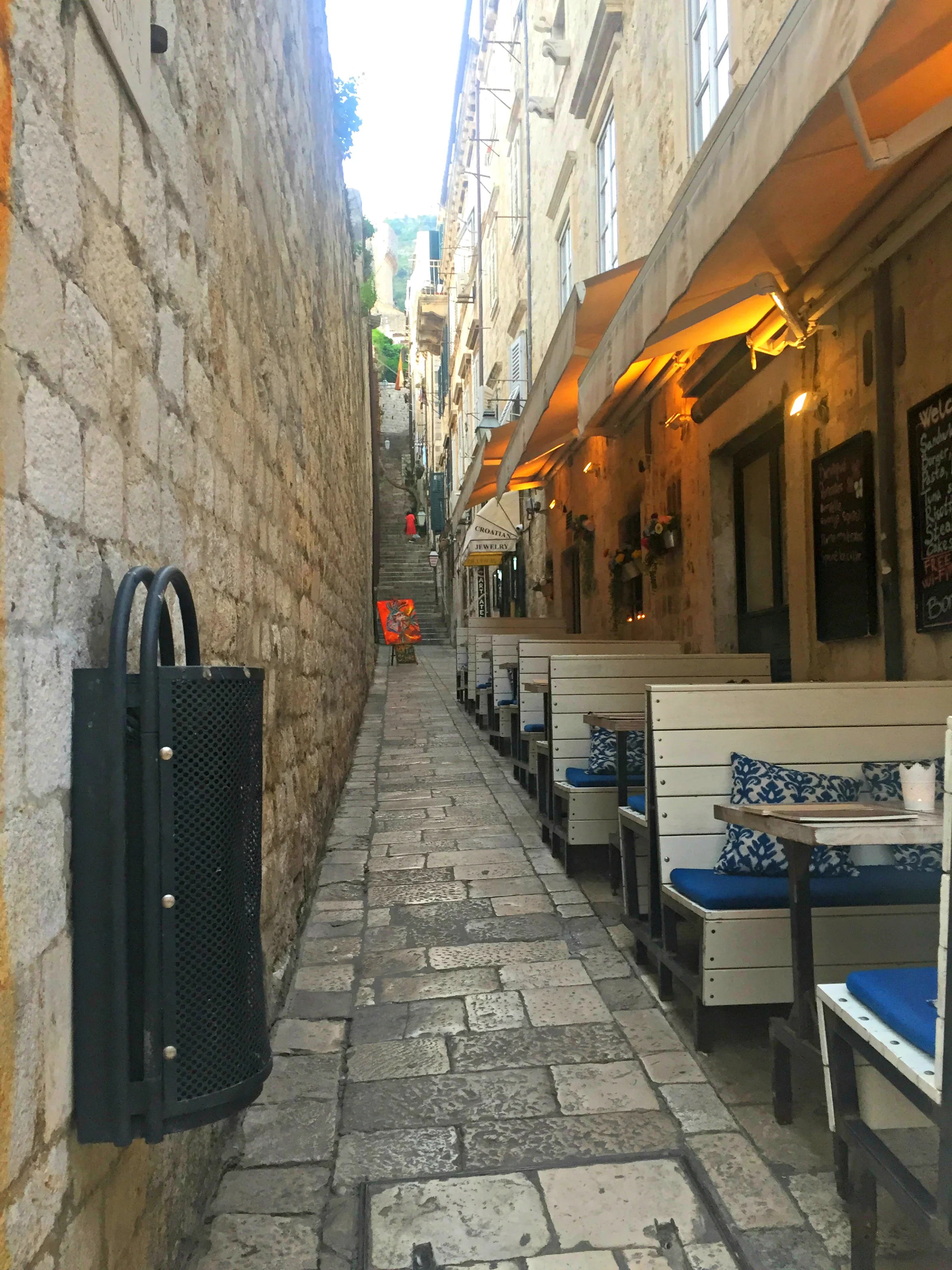 An example of a narrow walkway at ground level with stairs leading to - who knows?!&nbsp;