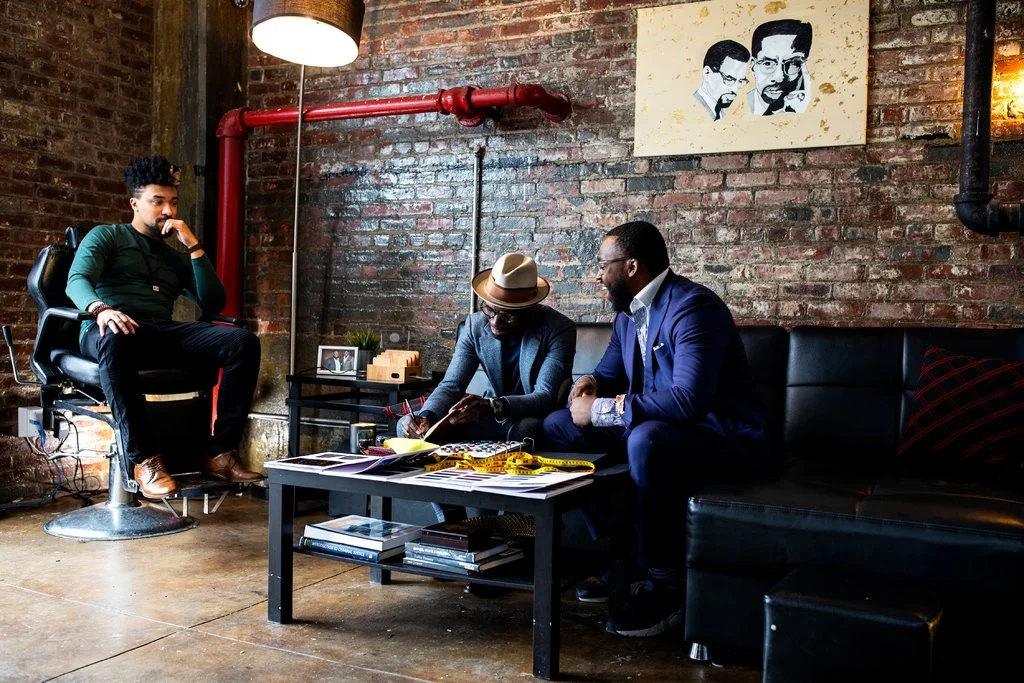 From left, Tim Jack, Prince James and Jeff Lindor at The Gentleman’s Factory in Brooklyn. Photo Credit Demetrius Freeman for The New York Times