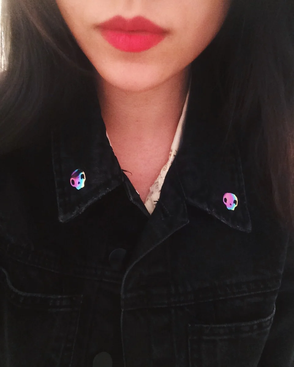 rainbow skull anodized metal enamel oil slick lapel pin originally designed by lilly baik.