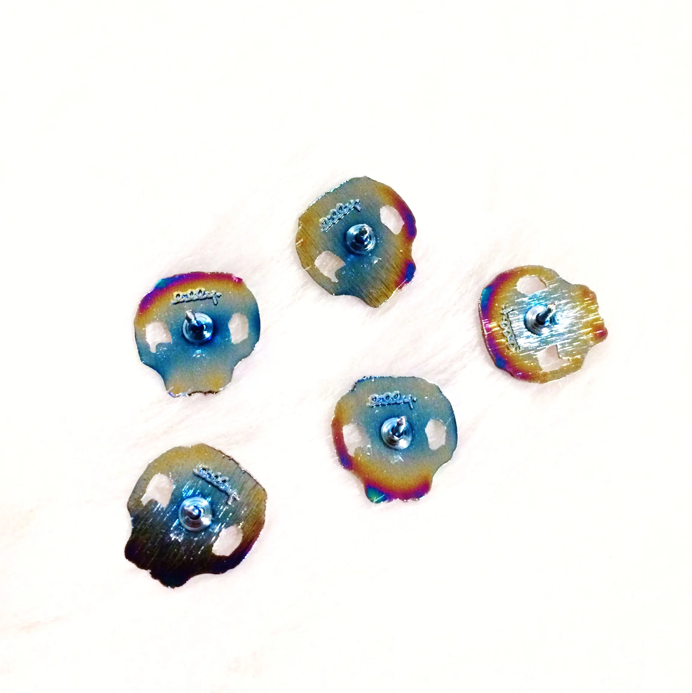 rainbow skull anodized metal enamel oil slick lapel pin originally designed by lilly baik.