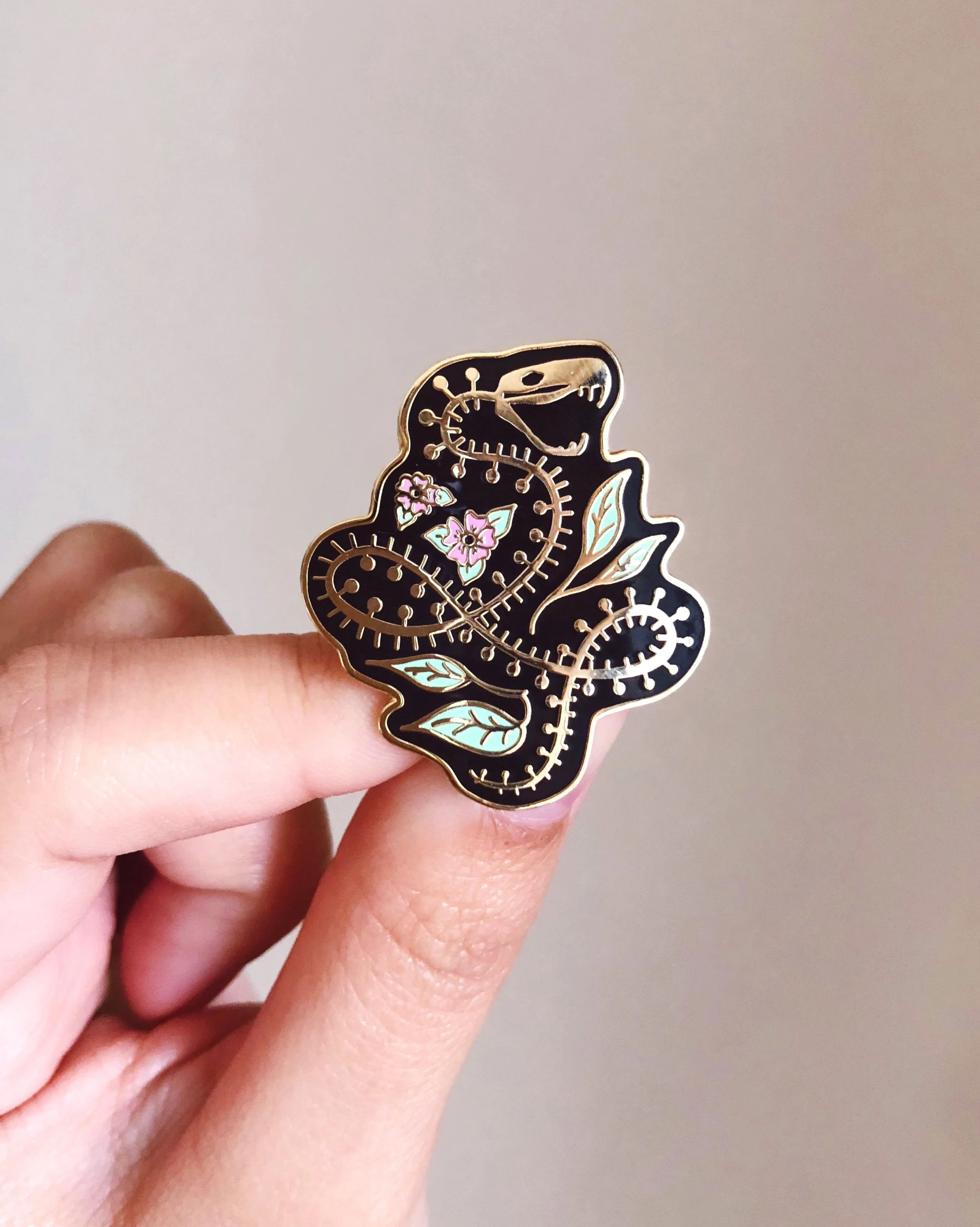 snake skeleton nature-inspired gold hard enamel pin by lilly baik.