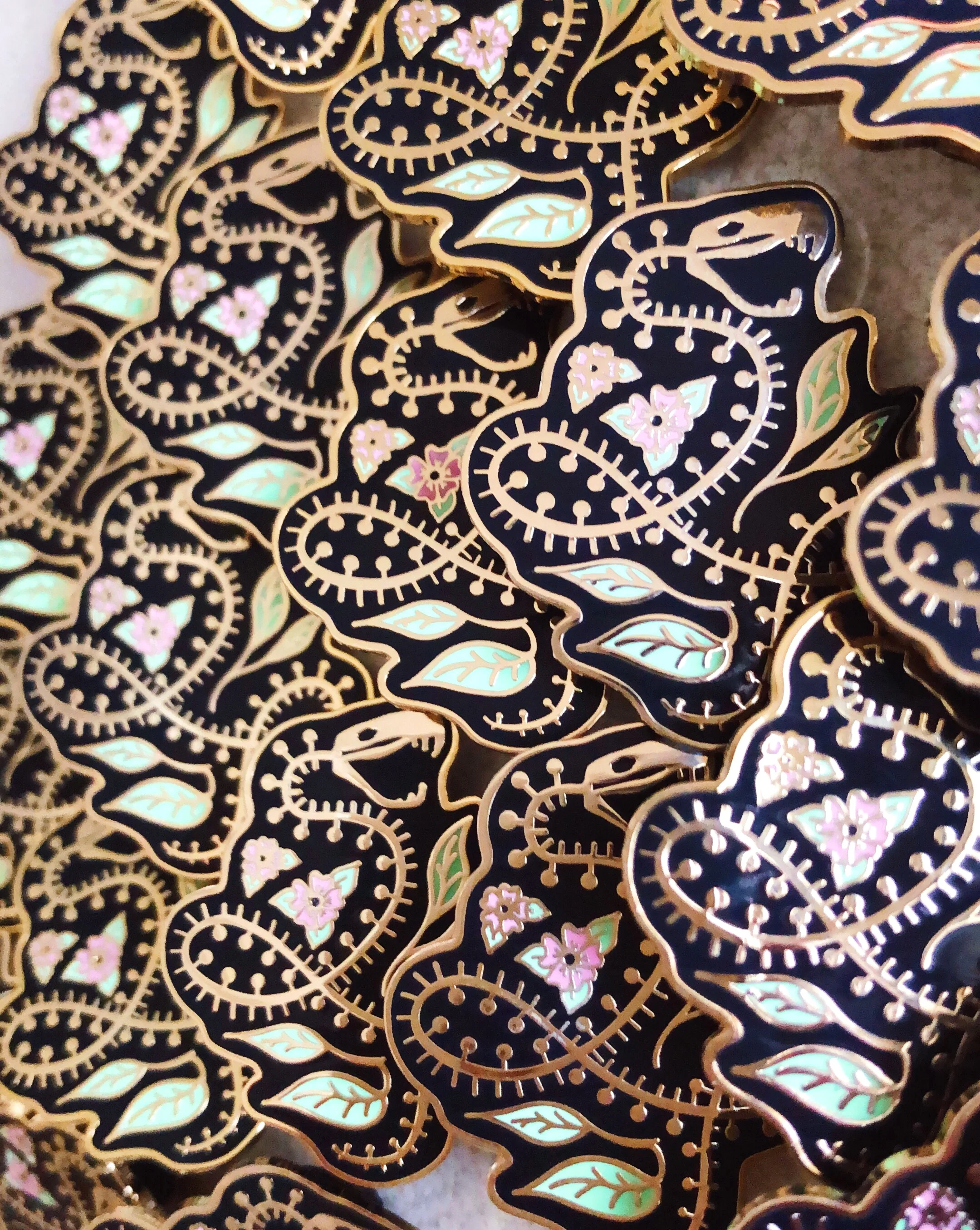 snake skeleton nature-inspired gold hard enamel pin by lilly baik.