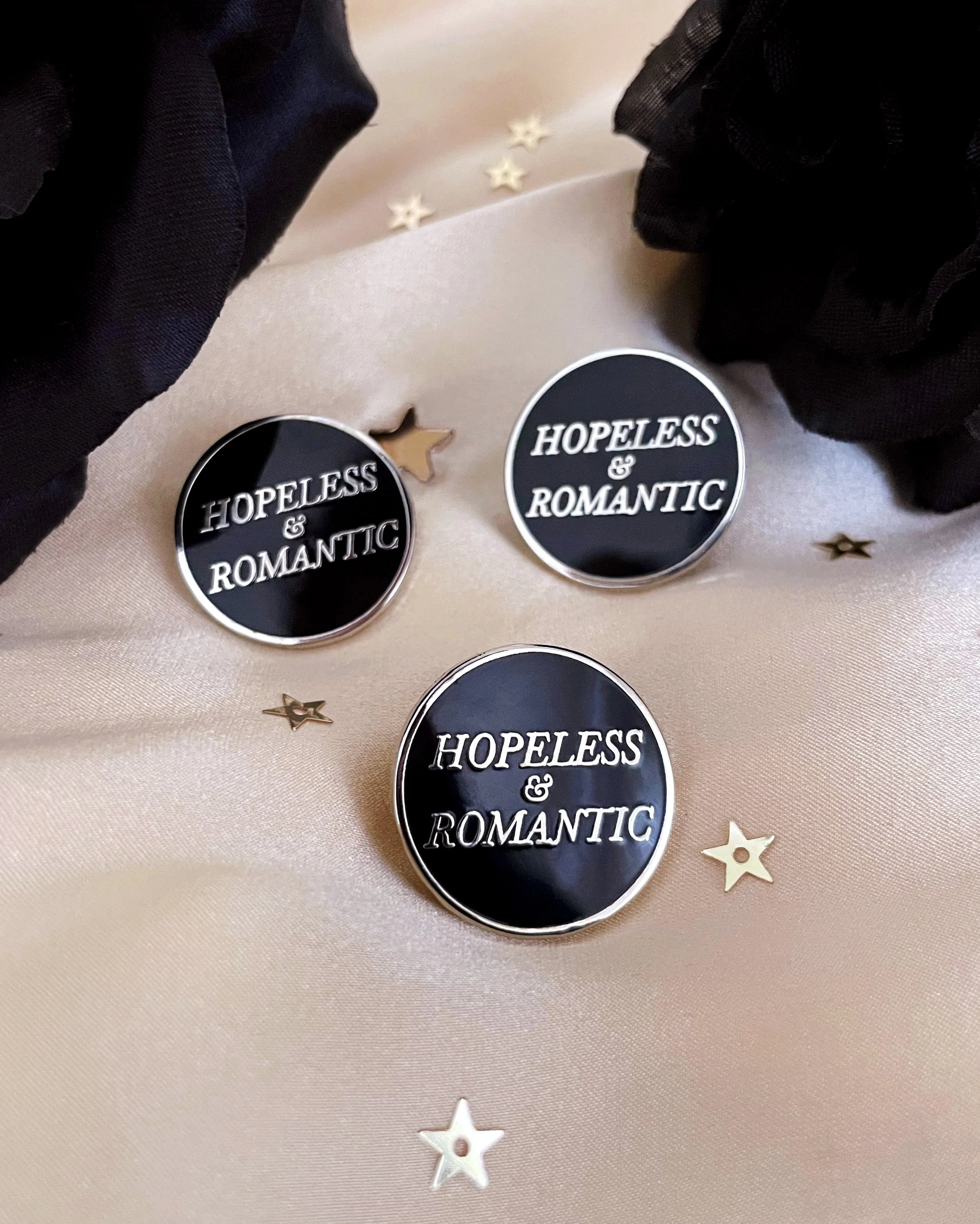 hopeless and romantic black and silver hard enamel pin by lilly baik.