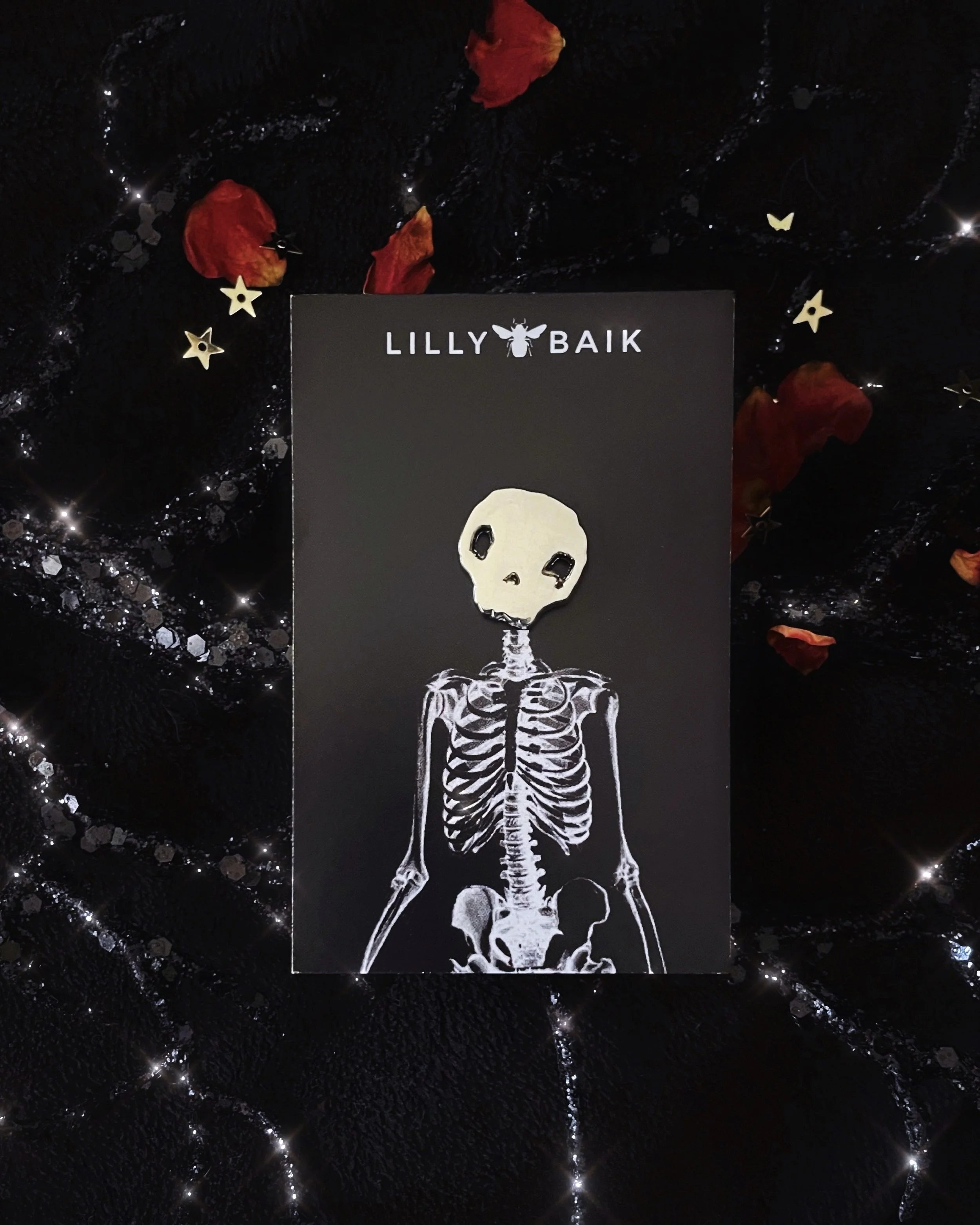 silver skull mini lapel pin by lilly baik.
