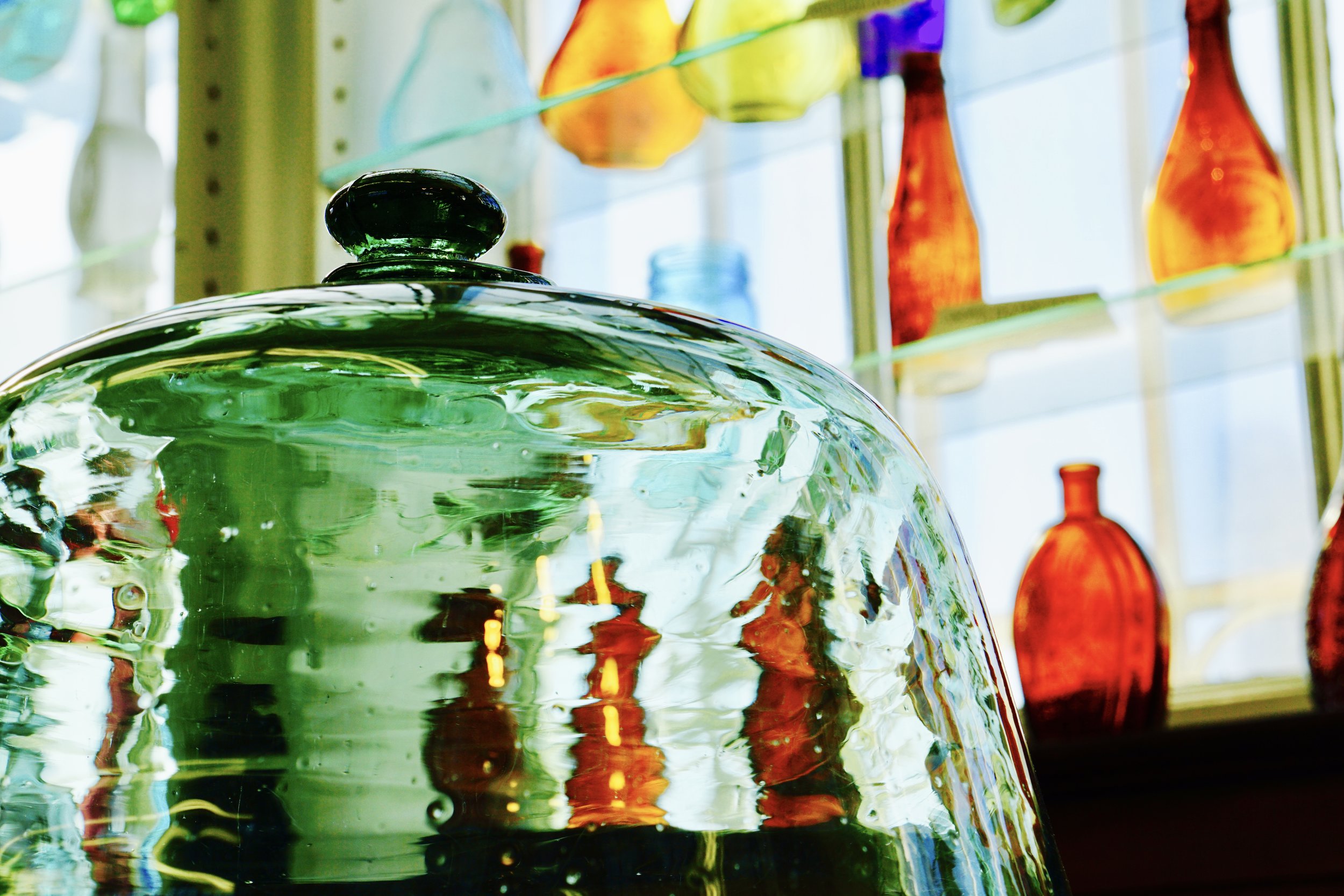 A colorful photo of glass artifacts within the Heritage Glass Museum.