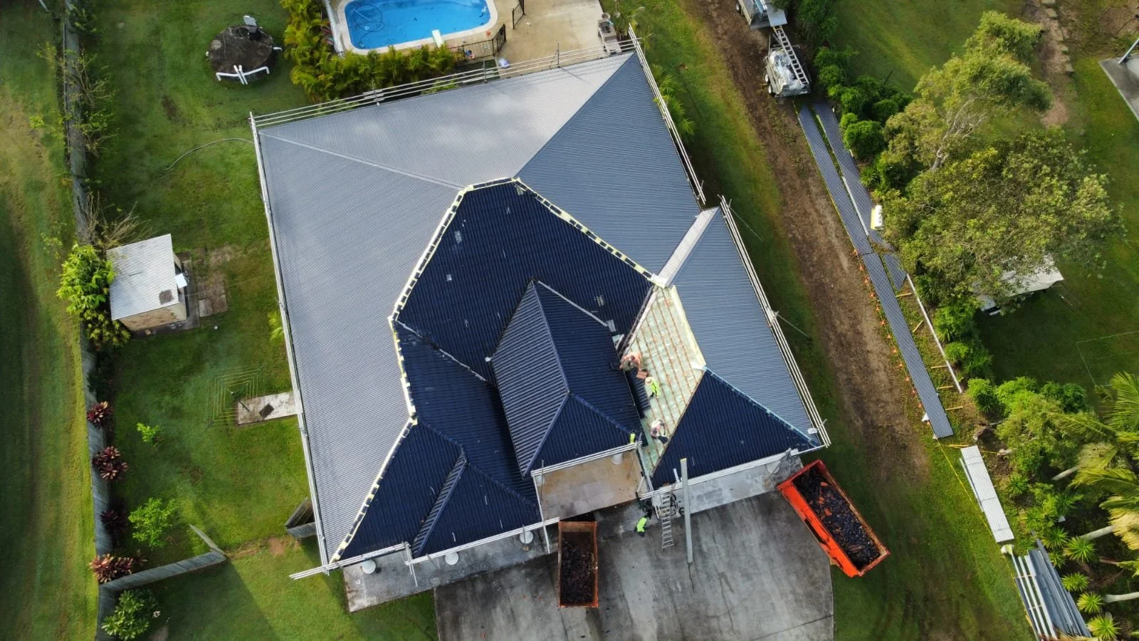Tile to Metal Roof Replacement with Colorbond corrugated sheets, caps and flashings in the colour Ironstoneยฎ (New Beith, Queensland).