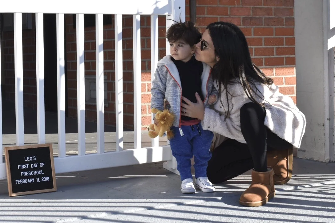 Mama having an intimate moment with her son on his first day of preschool.