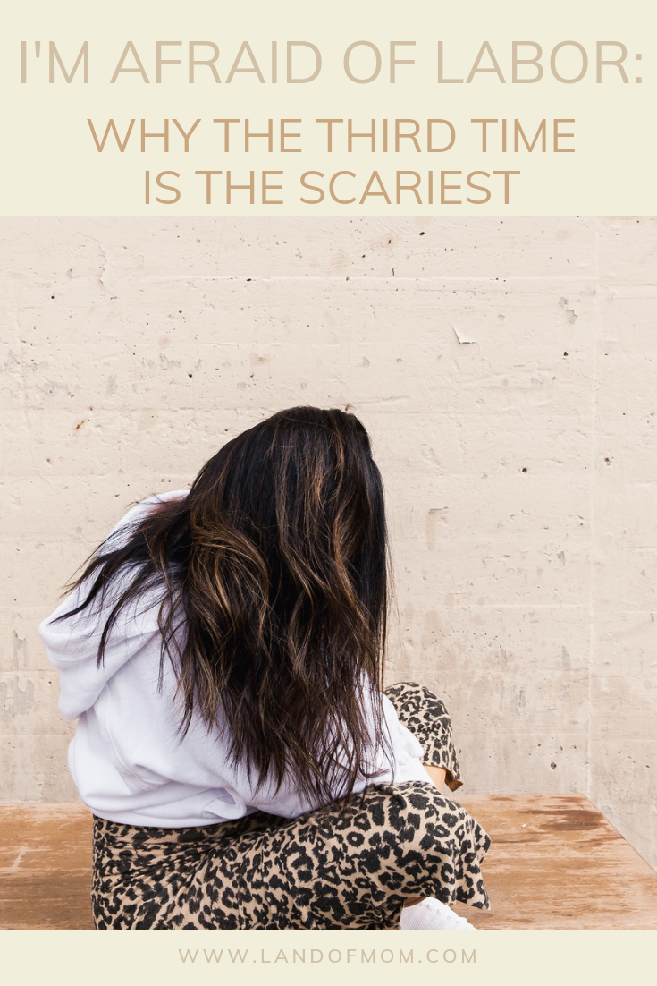 Pinterest Graphic for “I’m Afraid of Labor: Why the Third Time is the Scariest.” Image of El Abad sitting cross-legged wearing leopard print pants, white hoodie, and white sneakers. Hair draped covering face.