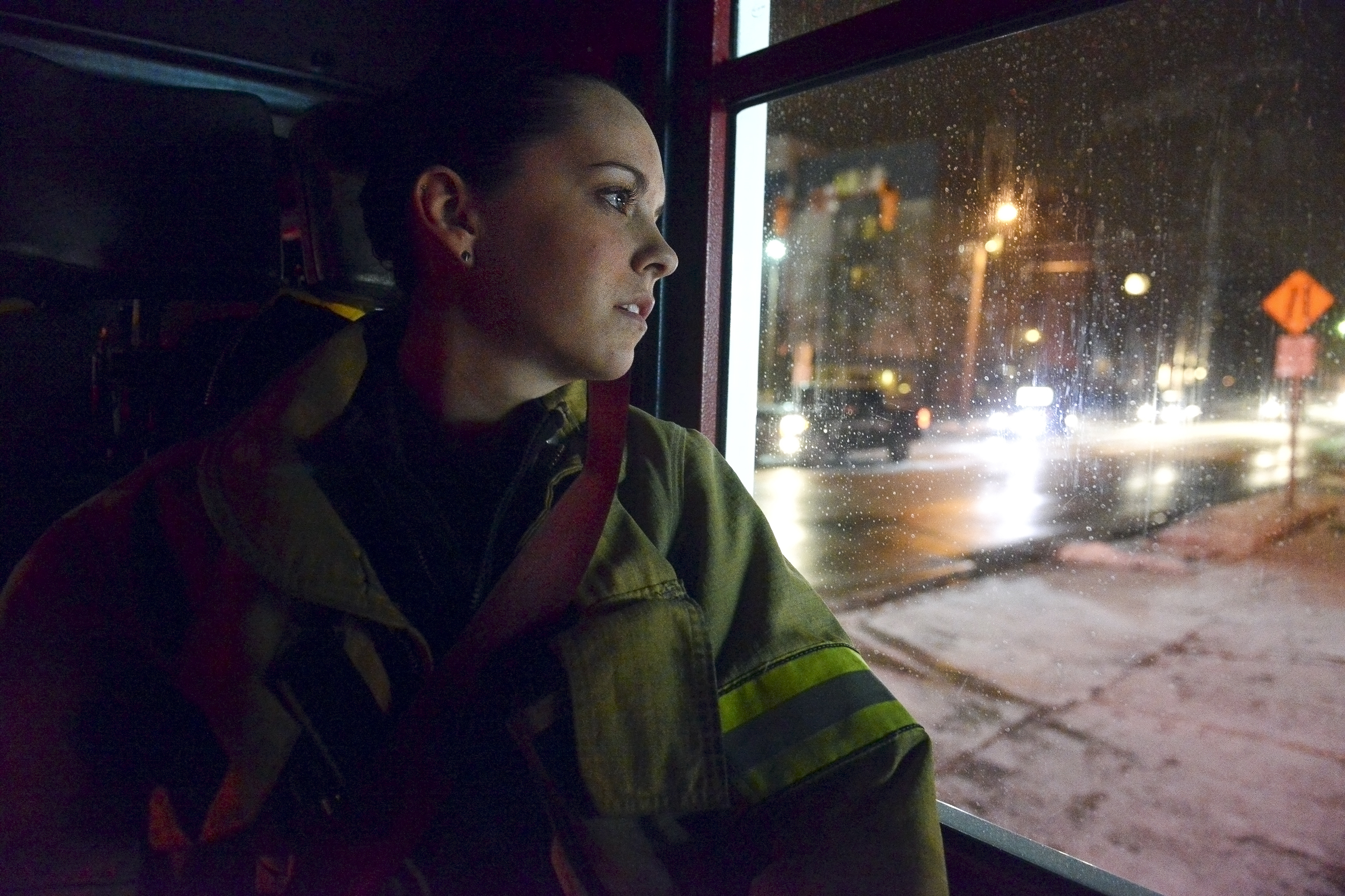 Ali Warren, a 20-year-old volunteer firefighter for the Alpha Fire Company, watches out the window of the fire engine as they arrive back to the station on South Atherton Street in State College, Pa. Warren, a State College local and self-published writer, has been volunteering for the company since she was 16. 