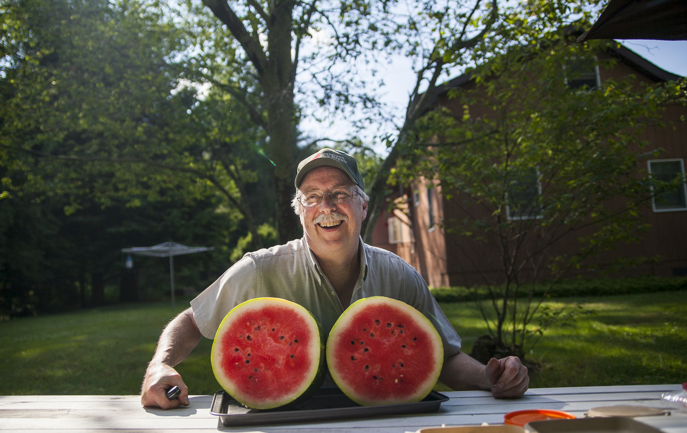  John Peterson poses with a watermelon he just chopped in half in Clarendon, Pa.&nbsp; 