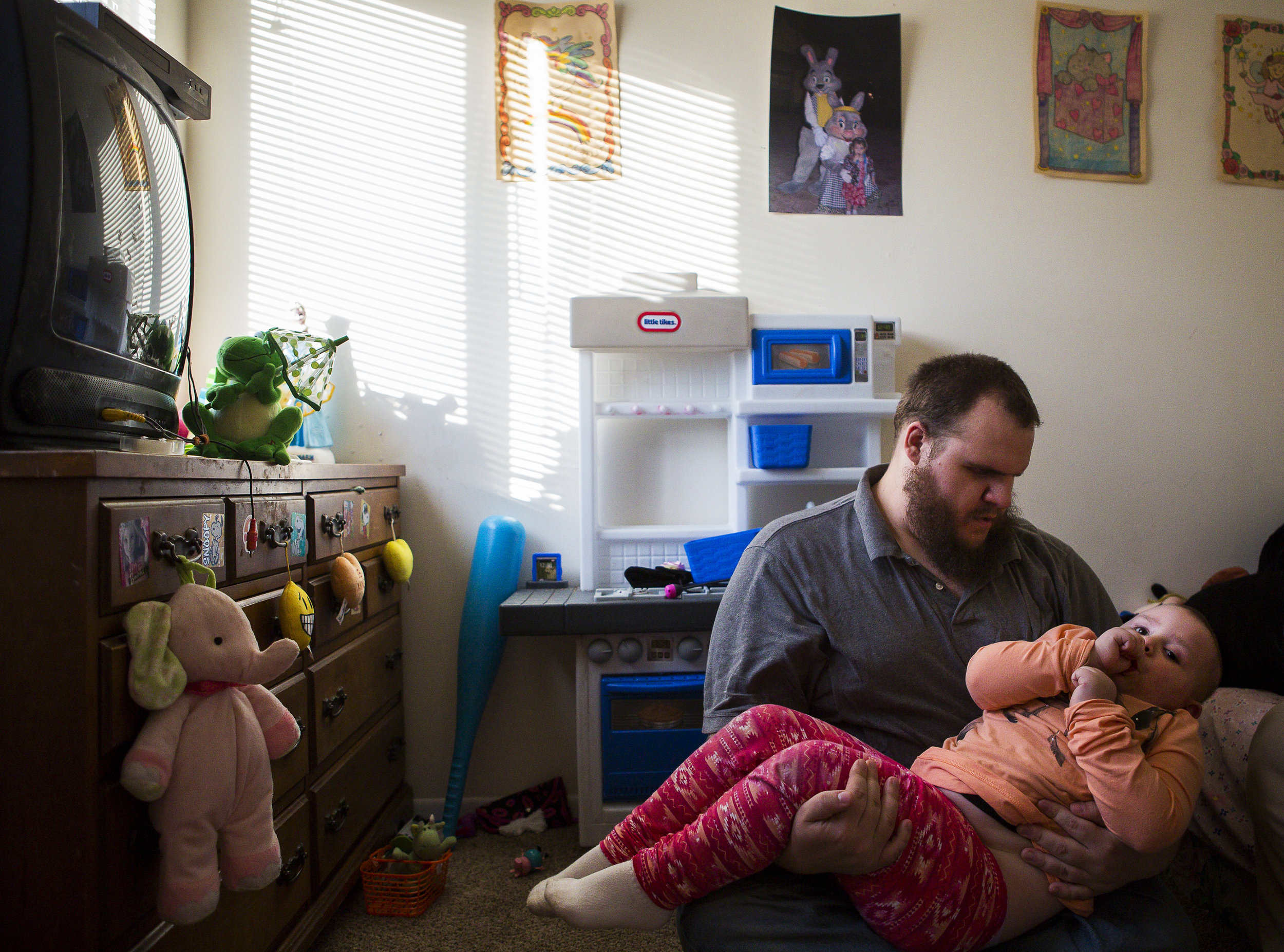 Cassie cuddles with her dad, Sean, also a survivor of retinoblastoma. The pair share a special bond having both battled retinoblastoma.