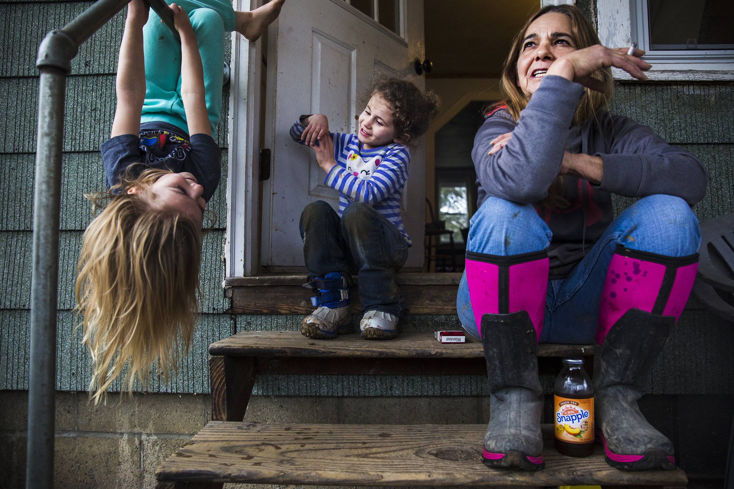  Mary Jonas enjoys an evening on her stoop with granddaughter Emily (5, far left) and friend Emma (4). Emma and her sister used to rent the house next door to the Jonas’ with their mother but recently moved to Belpre. The two sisters, along with the 