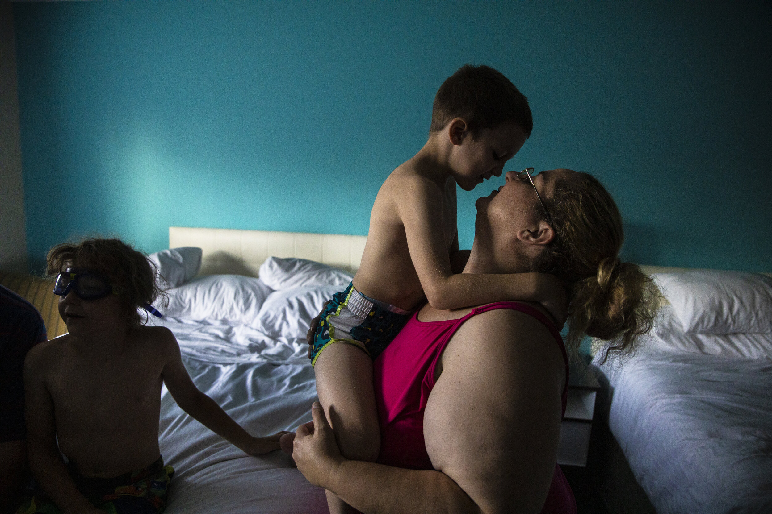 Mariah LeMieux-Lupien picks up her son Dylan and holds him close to her face while spending a night at a hotel in Portland, ME. Earlier in the day, the Lupien's packed up from the campground for good 