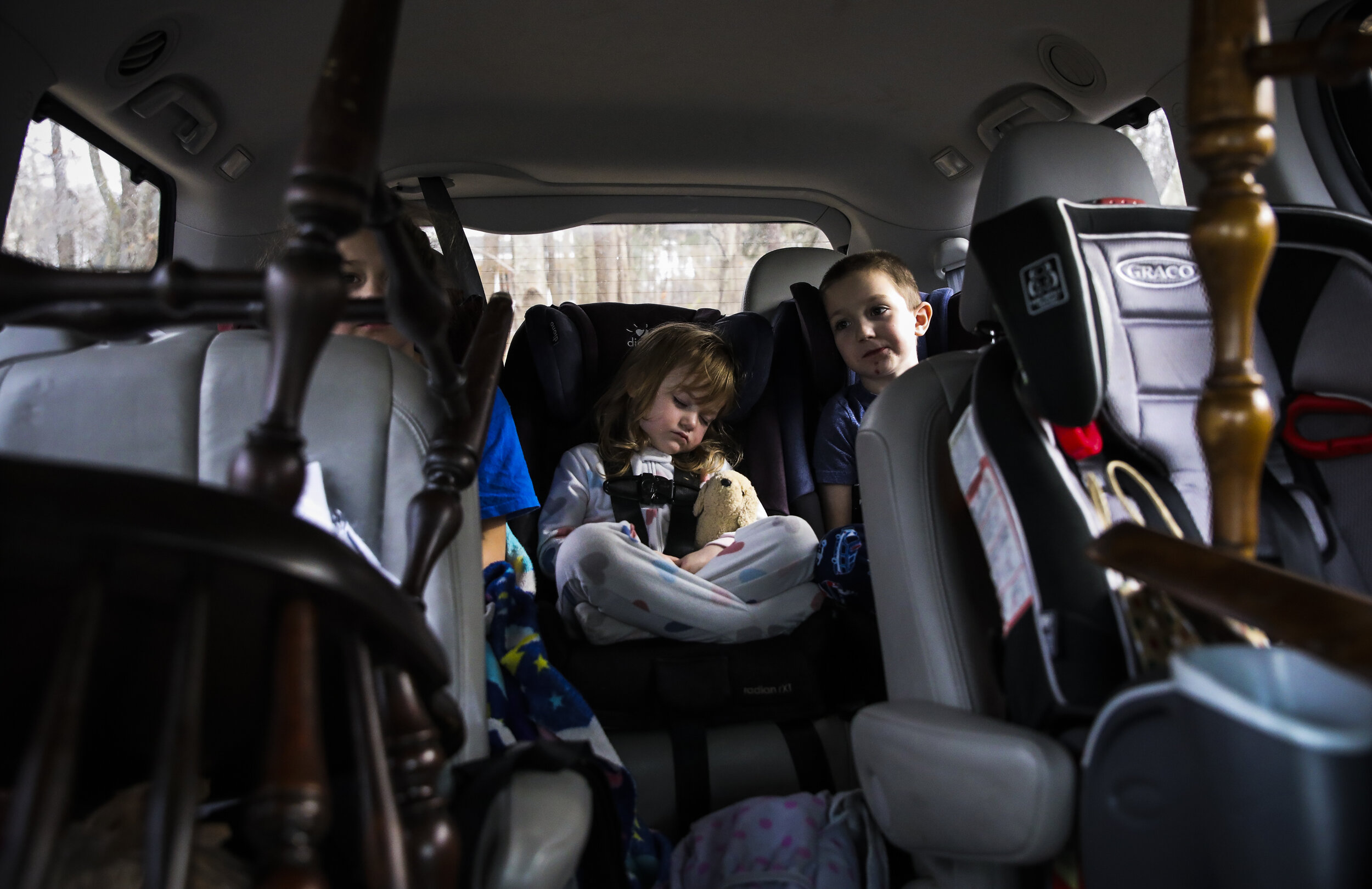  Laya Lupien sleeps in the back of  the van with her siblings amid dining room chairs and various odds and ends en route to the Lupiens new apartment in Dover, NH. Since July, the Lupien family has be
