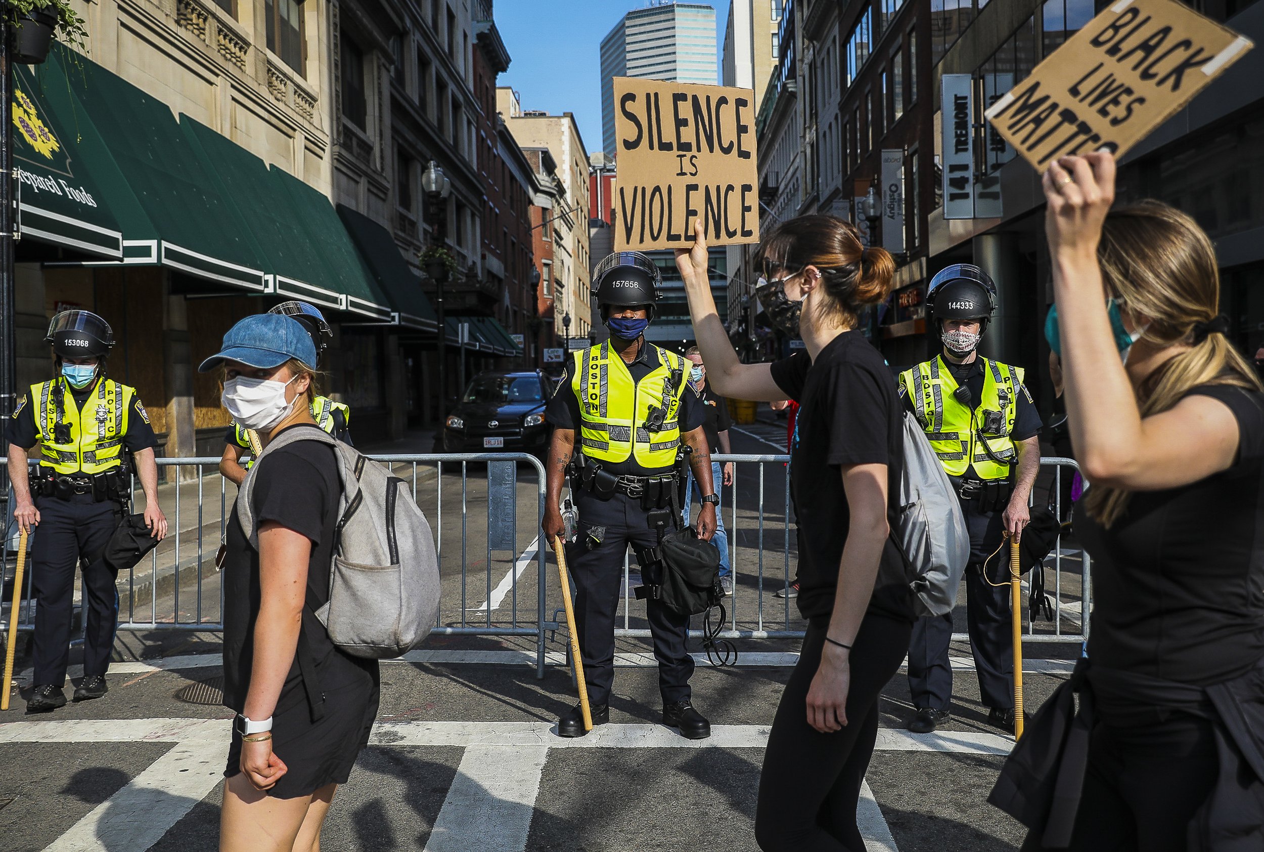  Protesters spill out onto Tremont Street, walking past the Boston Police, after gathering in Boston Common to honor the life of George Floyd and other Black lives taken at the hands of police. After gathering in the park, demonstrators marched throu