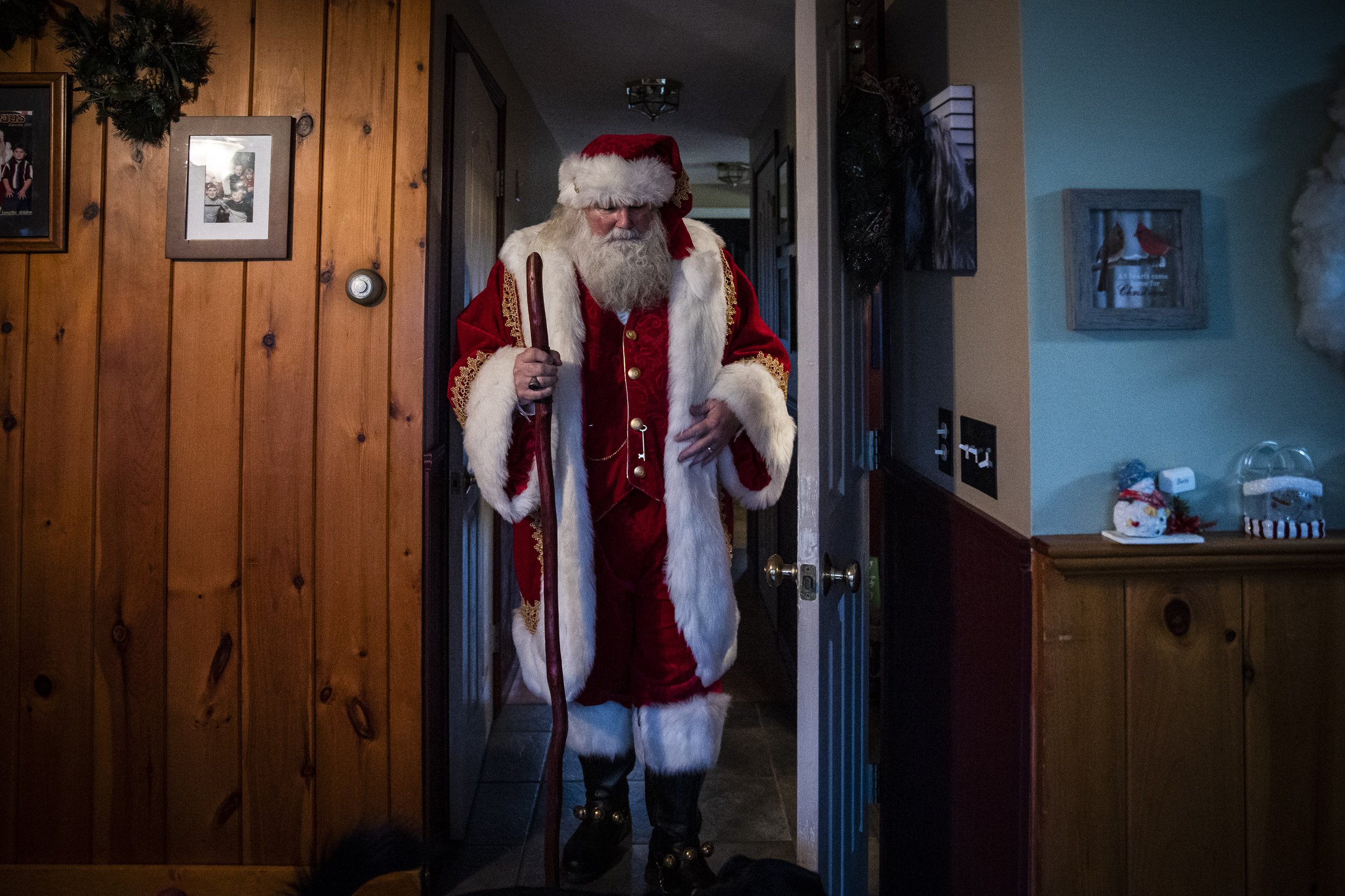  Rick Banks finishes getting dressed while at his Chichester, NH home on December 10, 2022. He’s chosen to wear his “Adele” Santa suit today. That’s the velvet one with gold brocade embellishments, reindeer buttons, and a silk-lined cape. It is the A