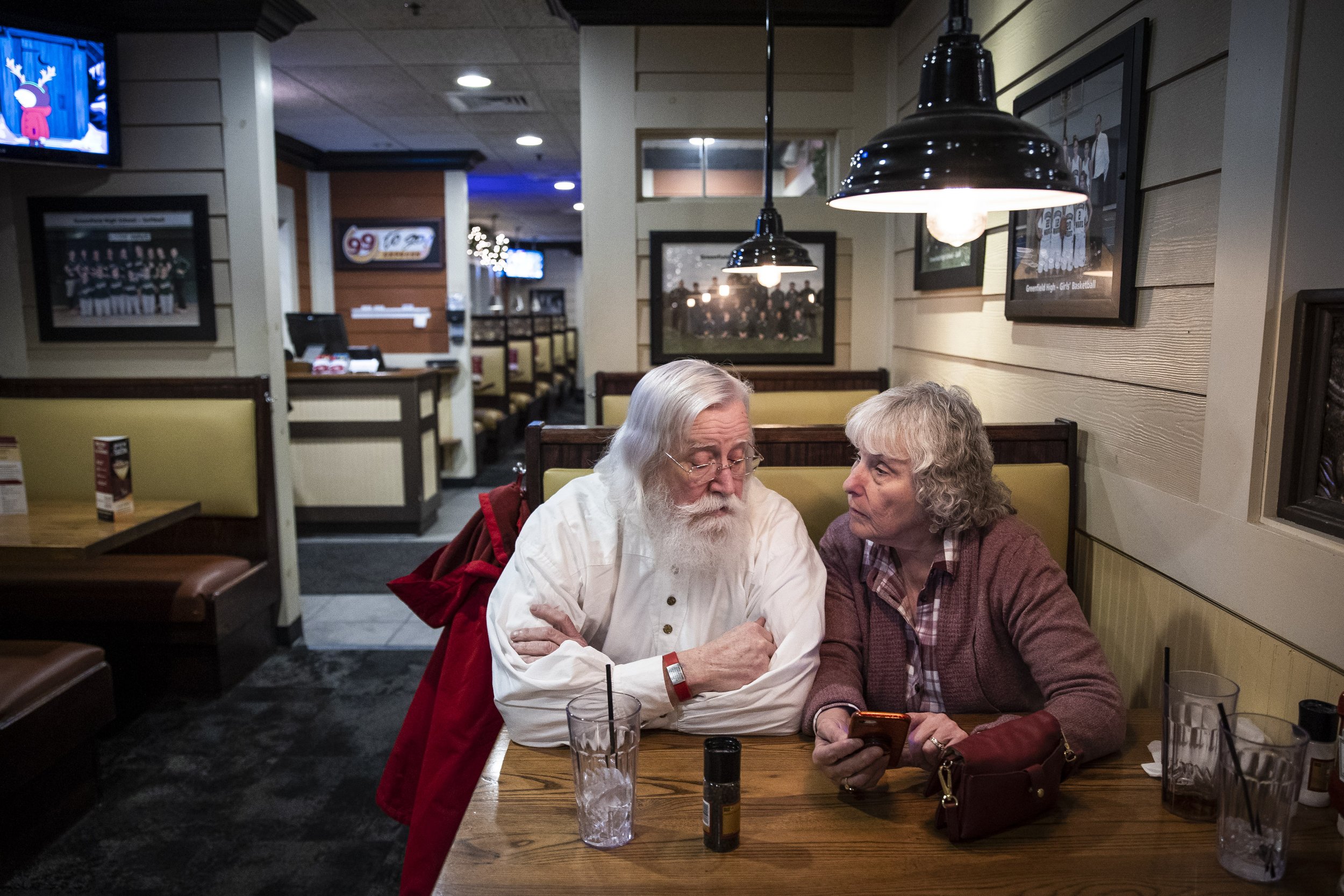  Lenny and Becki Stratton sit at 99 Restaurant in Greenfield, Mass. and go over their Claus schedule for the week on December 11, 2022. There are two weeks left until Christmas and they don’t have many days left open. The couple makes sure to keep th