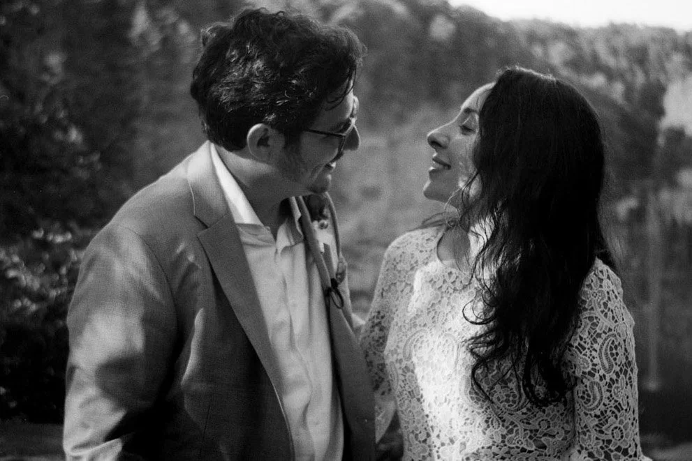 A newly married couple looking at each other.