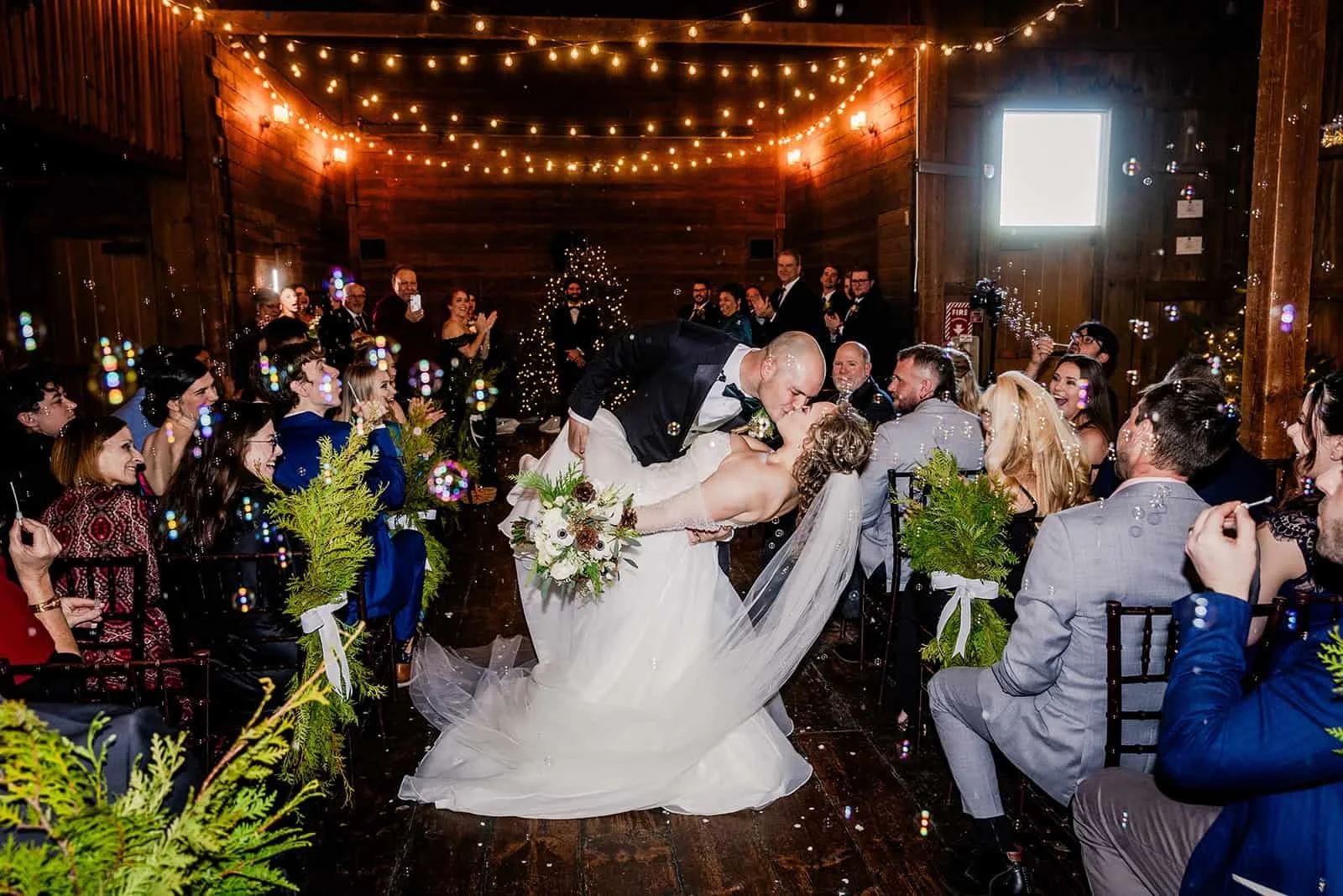 Bride and groom kissing at the end of their wedding ceremony.