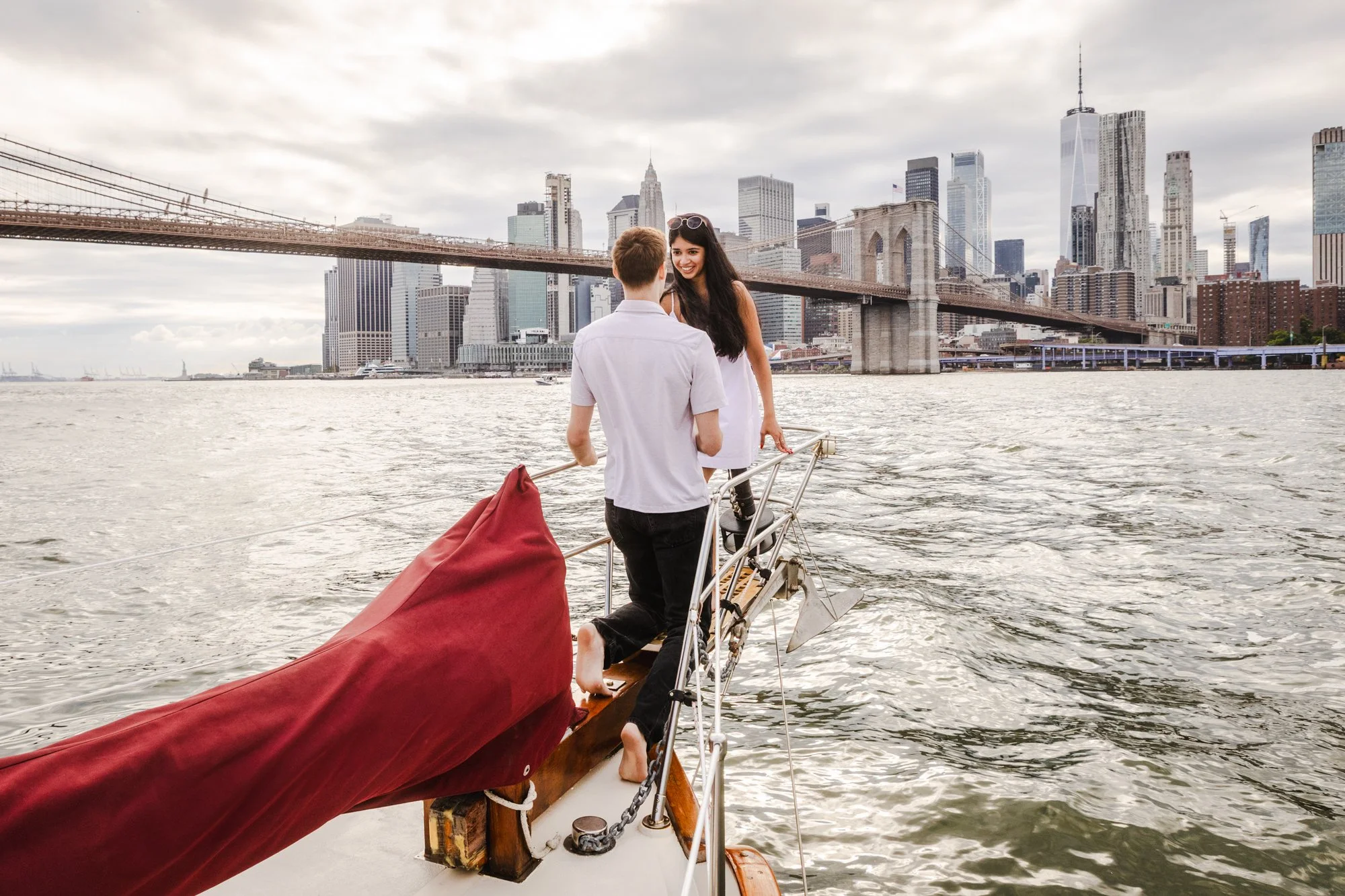 A man proposes to his girlfriend on a boat.