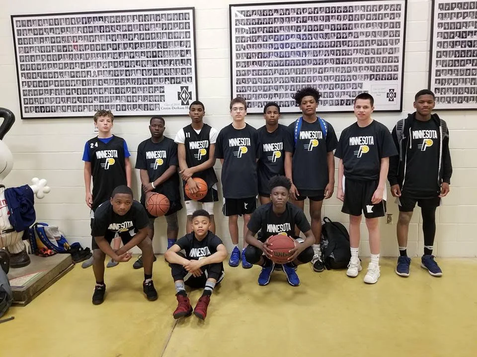 This is my team, the Minnesota Pressure, at the Preps Hoops Tournament at Cretin Derham High School in Saint Paul in May. My team went 3-2. We just put this team together this year, but I have known everyone on it since we were young, like fourth grade. All of them are like brothers to me, but one of them is actually my blood brother. He actually plays for the seventh grade Minnesota Pressure team, but he plays up with the high school team. A lot of people involved in the AAU program think less of our game because we just came out this year and no one really knows about us except people in our community. But we just won a championship in a tournament in Chicago, so now we have people who want to come play with us. 