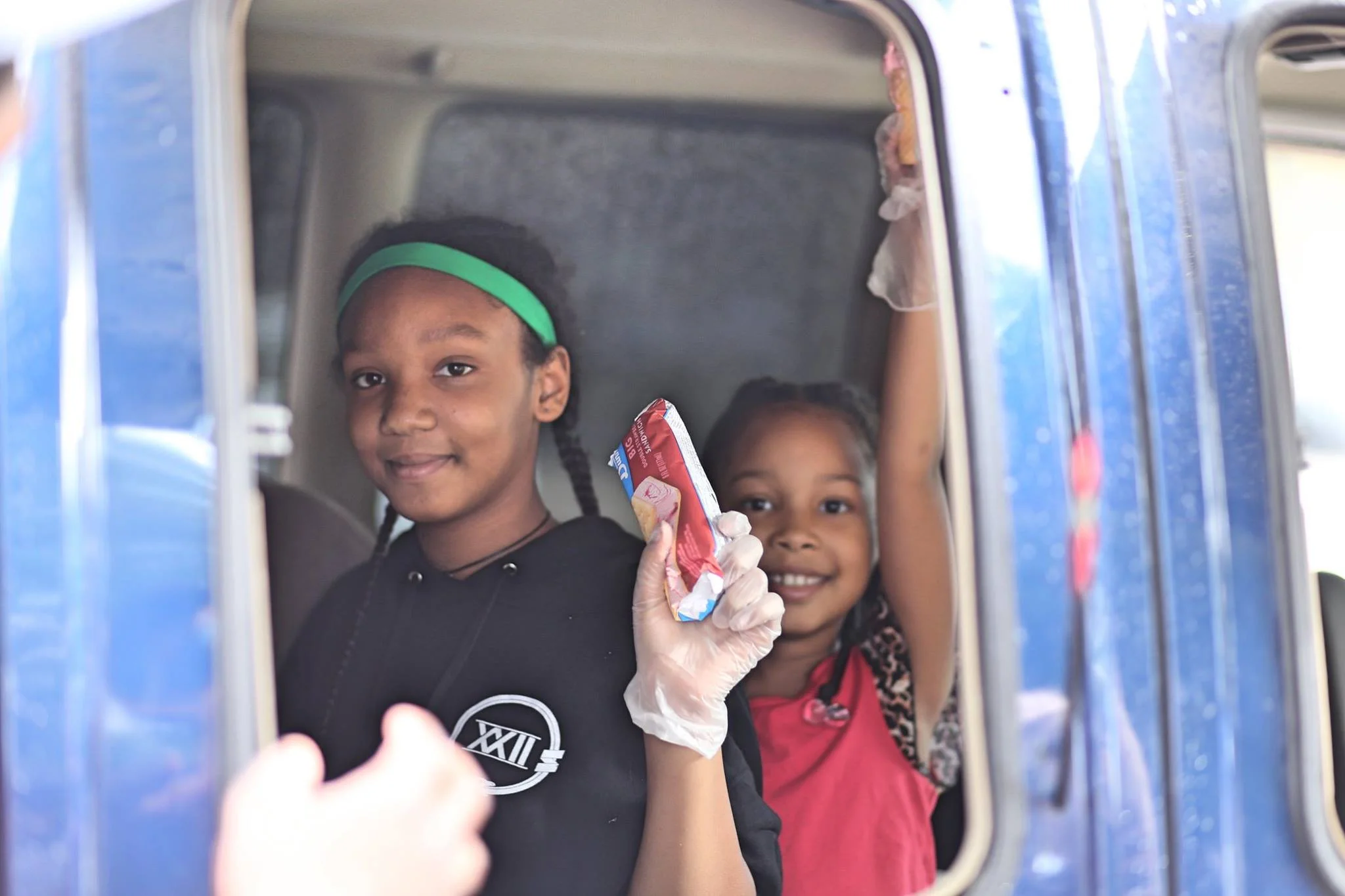 Isis and Oya Bridewell have been selling ice cream out of an old fashioned truck driven by their dad this summer. During Thursday night FLOW, they parked on Plymouth Ave. Photo by Azhae'la Hanson