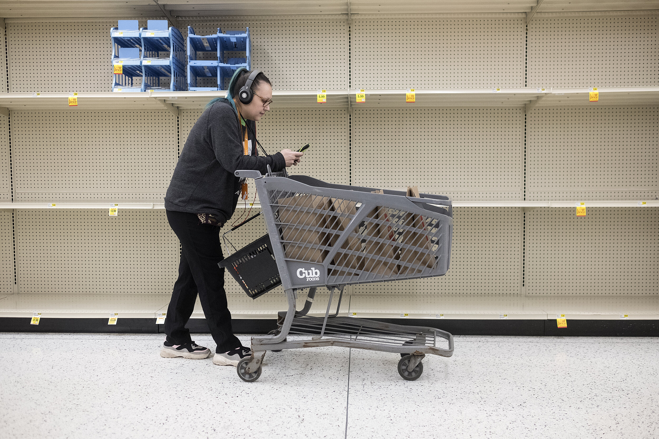  A shopper passes by empty toilet paper shelves at Cub Foods on West Broadway Avenue in mid-March.    