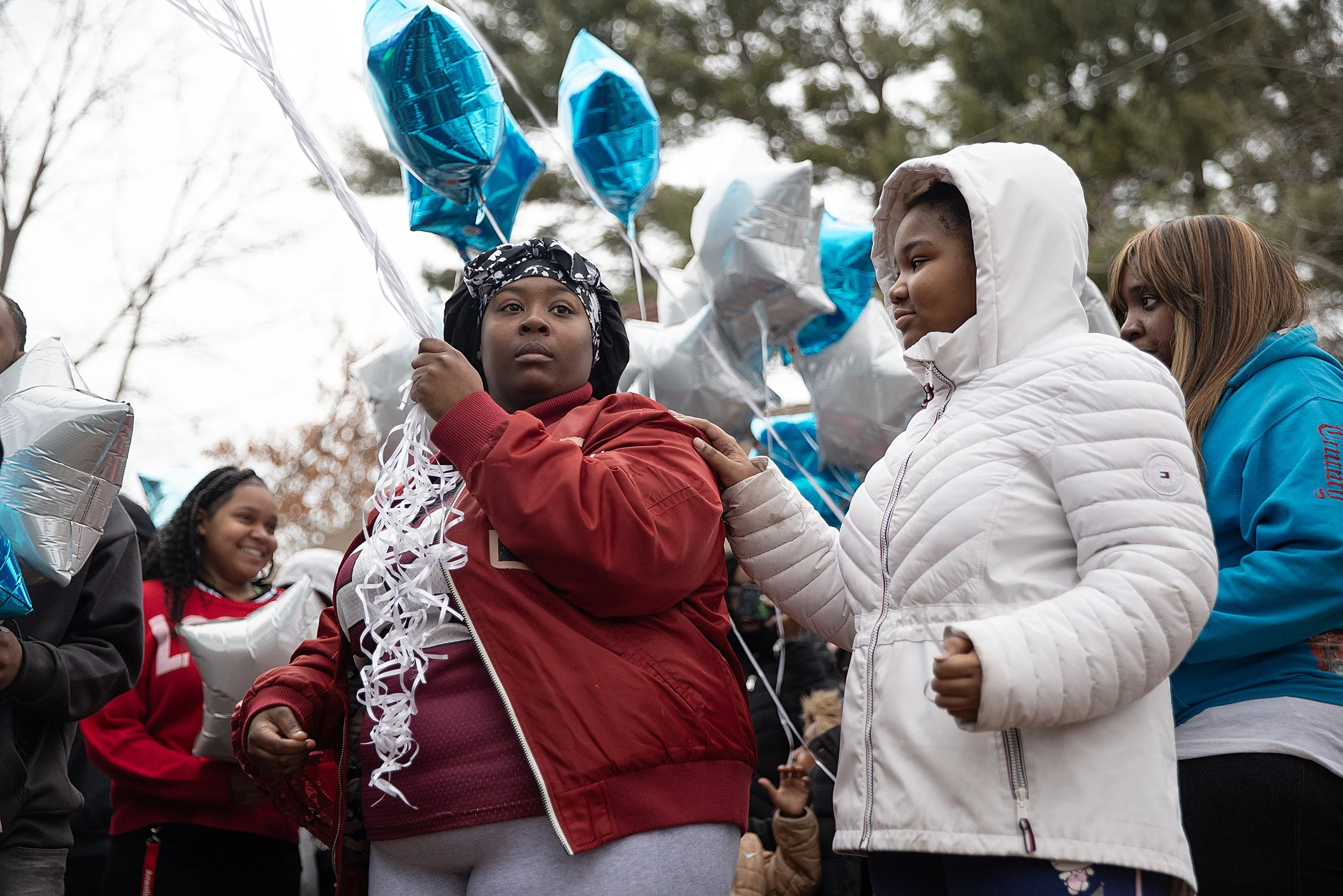 Mourners release balloons for brothers killed by a family member