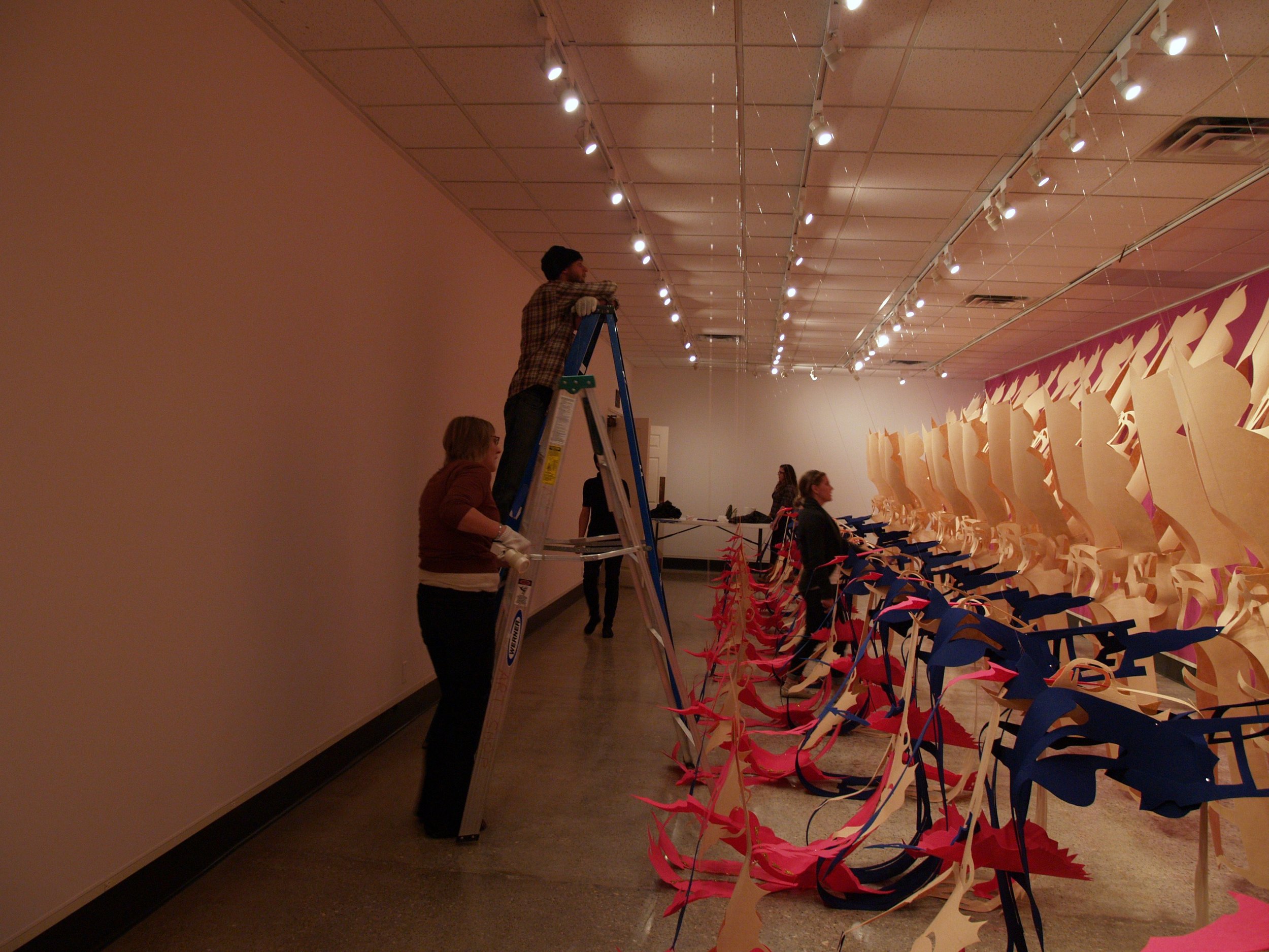 Gallery Director + students install Liz Miller's installation