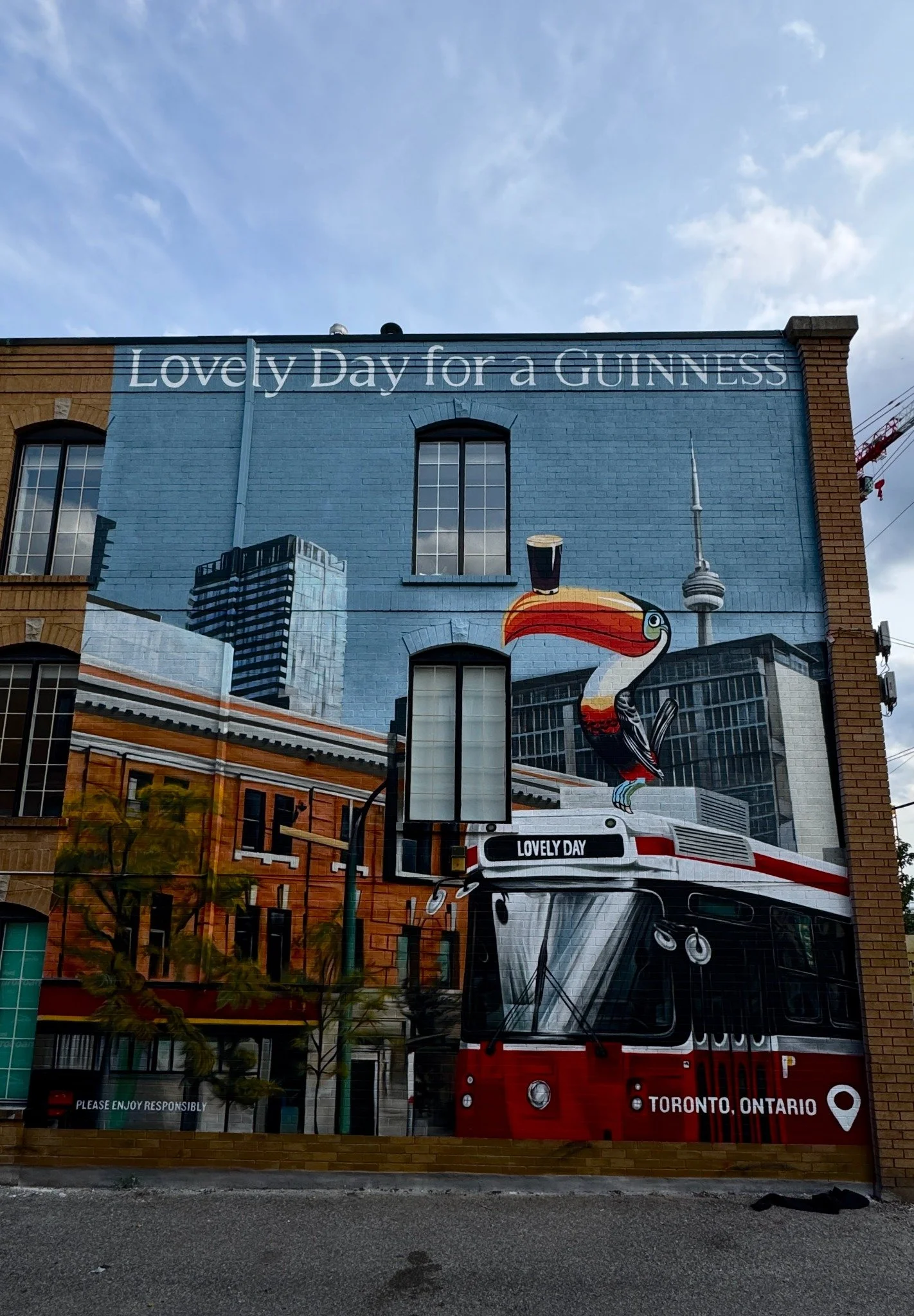 Guinness — Toronto exterior mural featuring the toucan, streetcar and CN Tower.