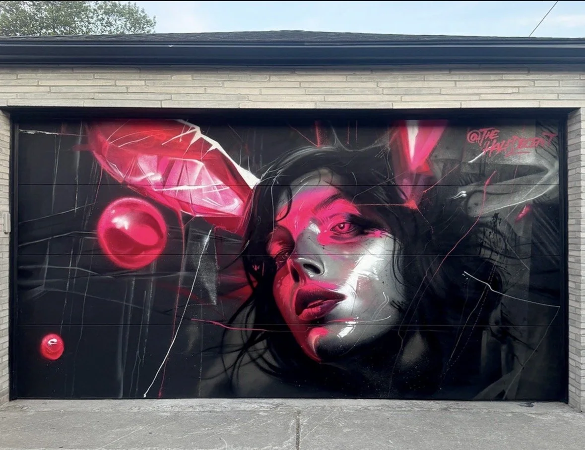 Pink and silver portrait mural on a garage door.