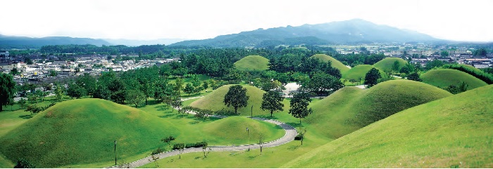 Gyeongju Historic Areas. Gyeongju was the capital of Silla for about one millennium. The city still contains a wealth of archaeological remains from the Kingdom, and hence is often dubbed as “a museum without walls or roof.” The photo shows a scene of the Silla mound tombs located in the city.