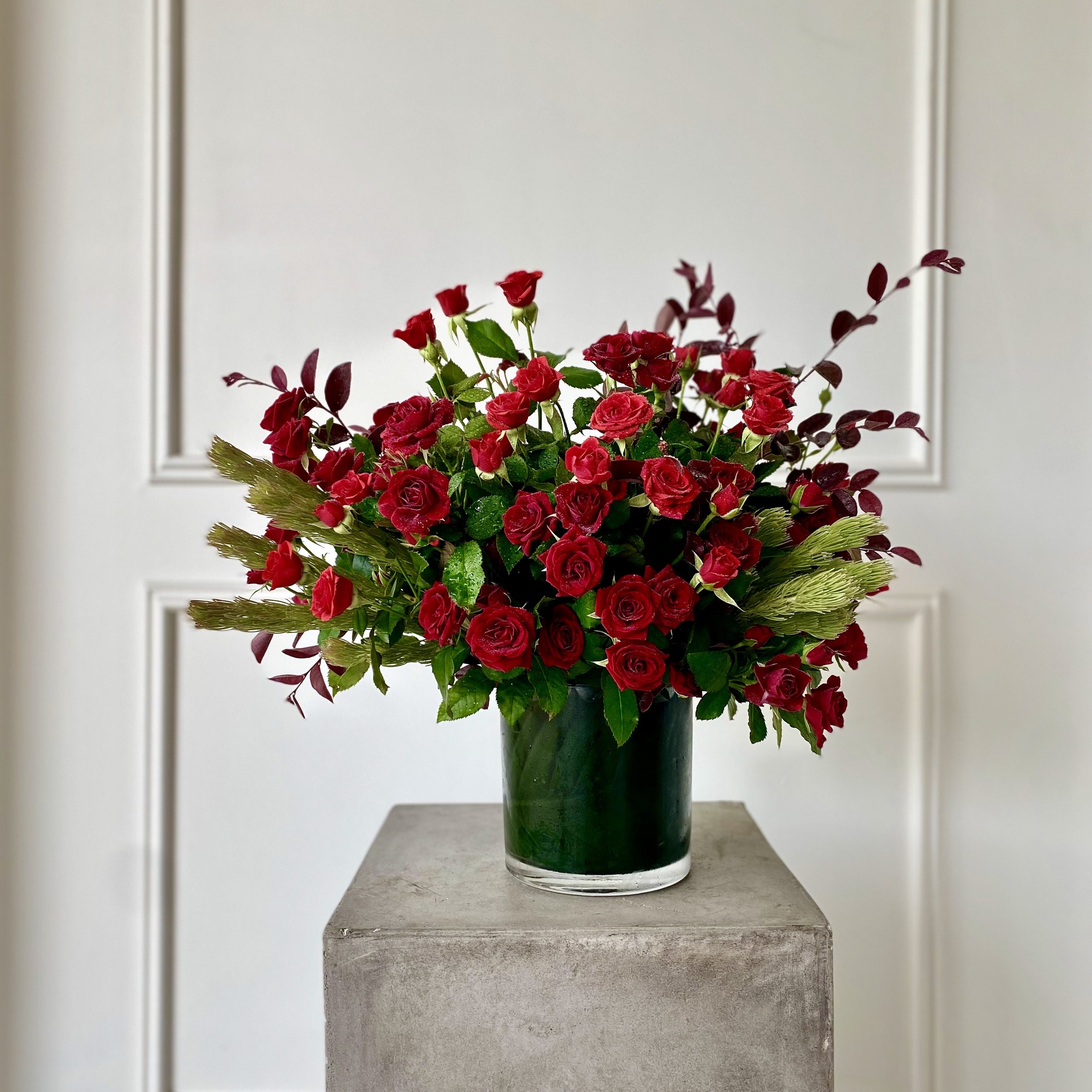 Vase arrangement of locally grown red spray roses.