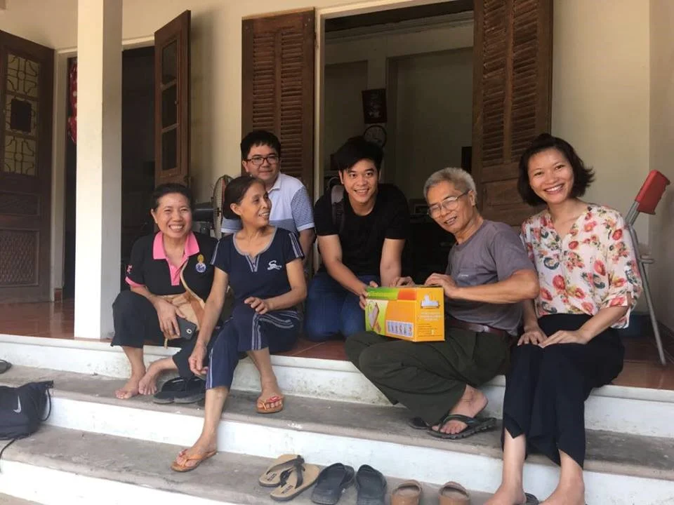 Photo 9: Group photo with the chicken farmer family. I am in the middle in black. The farmer is on my left hand and his wife is on the right hand. They are showing us a small vacuum sealer used for chicken packaging.&nbsp;&nbsp;