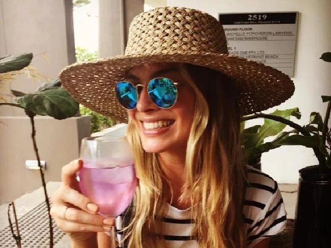 Margot Robbie enjoying a pink gin in the lead up to her Queensland marriage.