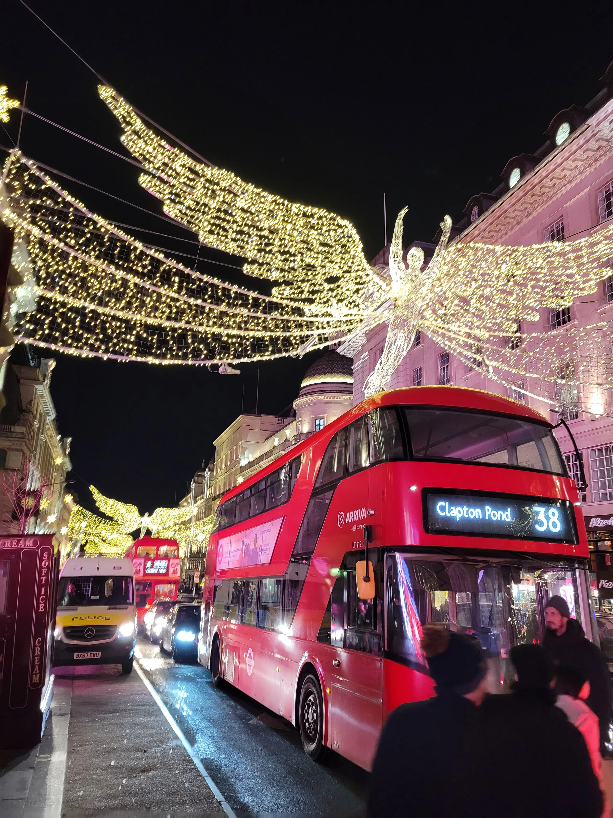 Red double-decker bus on a London street.