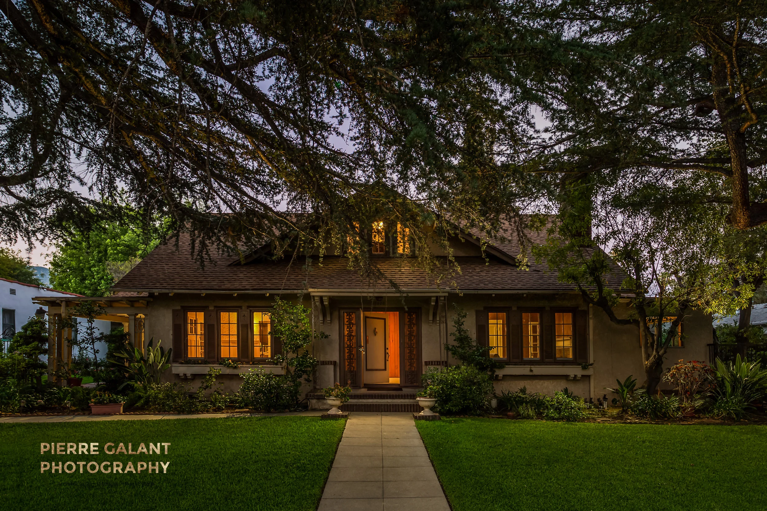 Here the challenge was to make an unfurnished house clad in 70's brown paint, more appealing. The answer was to incorporate a large pine tree in the front yard, but I wanted to do this is a way that would not worry prospective buyers about the proximity of such a large tree. So I framed the tree trunk out of the composition, and made the branches cover the sky as if it was a protective blanket. The added glow from the house and the open door really drove the point home that this is a safe and inviting place to live.