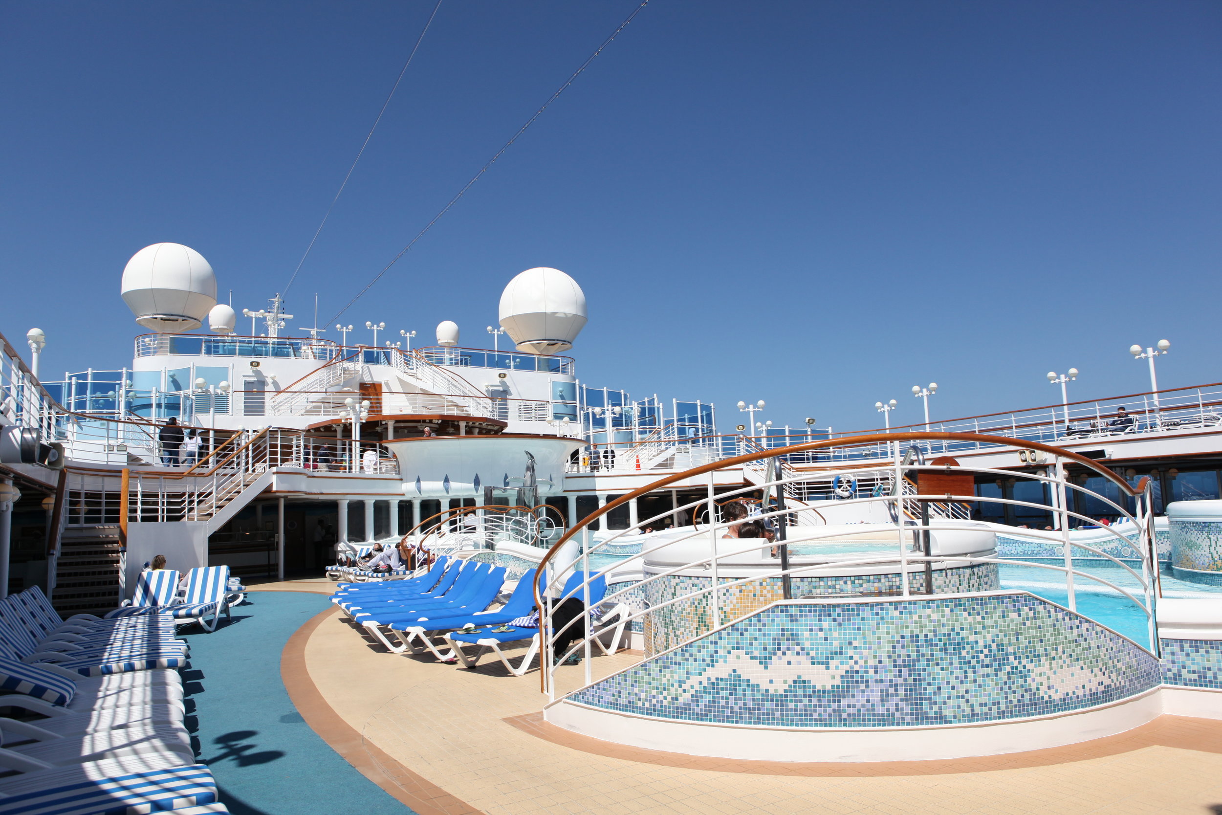  The pool area onboard. The large circular globes on the top of the ship are radars, integral to the geolocation and operation of the ship.&nbsp; 