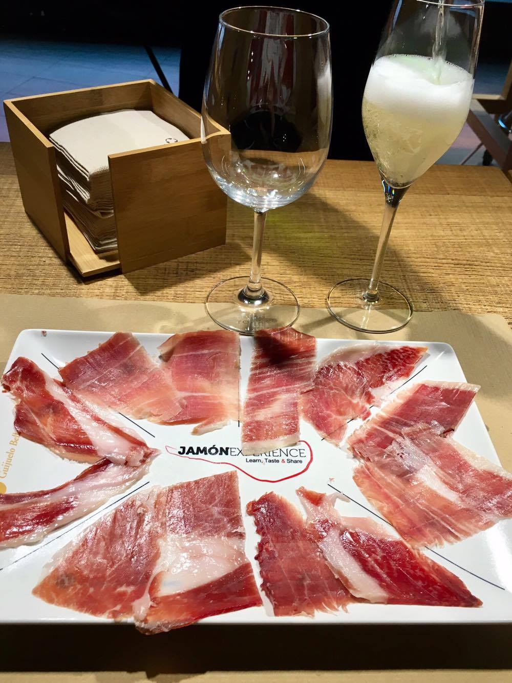 The four types of ham at the bottom are bellota, from acorn-fed pigs. The top left is serrano, and the right normal Ibérico. Notice how the bellota hams have glossier texture compared with the other two.