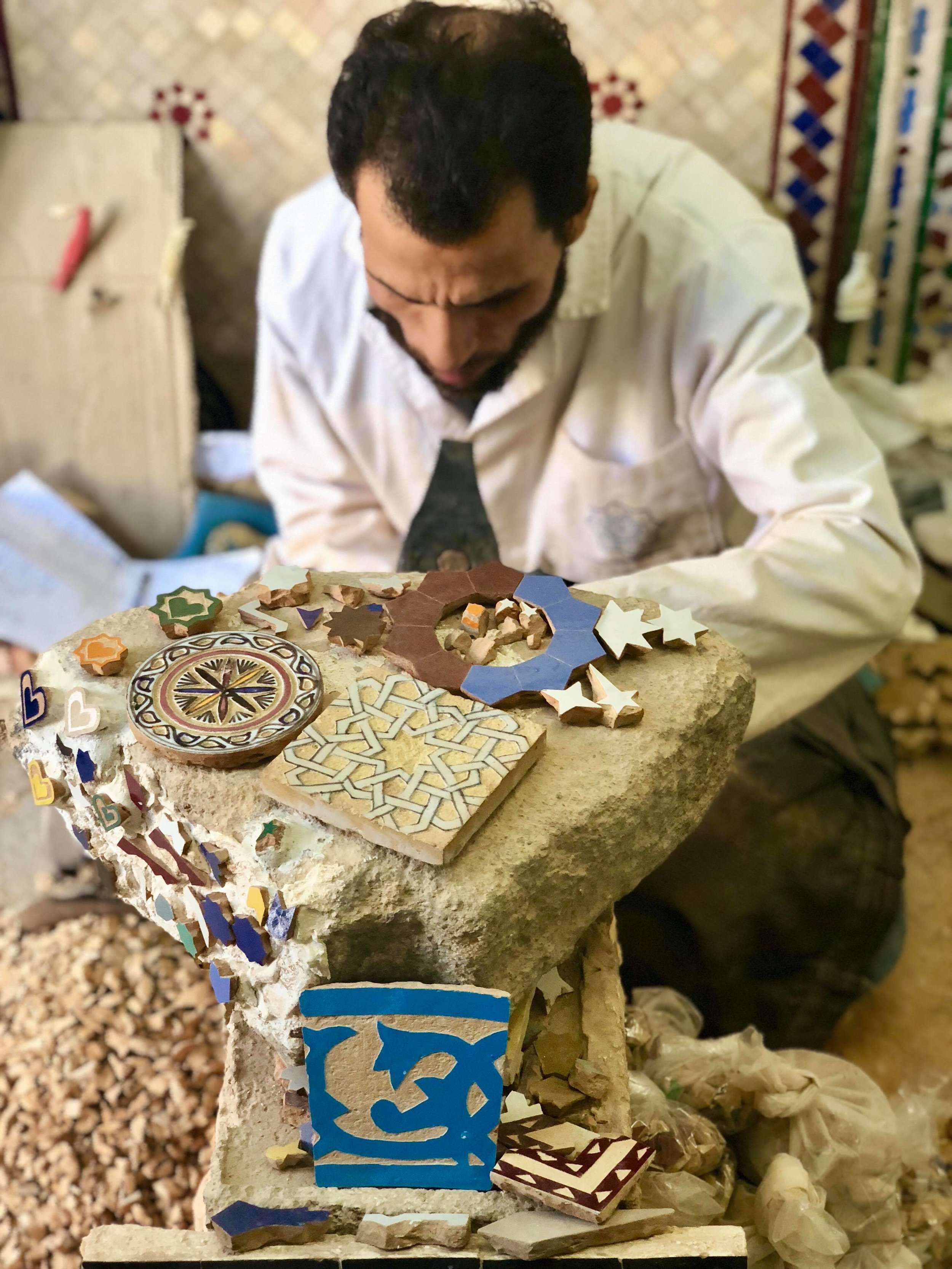  Mosaic pieces are then laid with their glazed and colored sides facing down, requiring the artisan laying out the design to memorize the mosaic's layout and be able to assemble the pieces on its flip-side. 