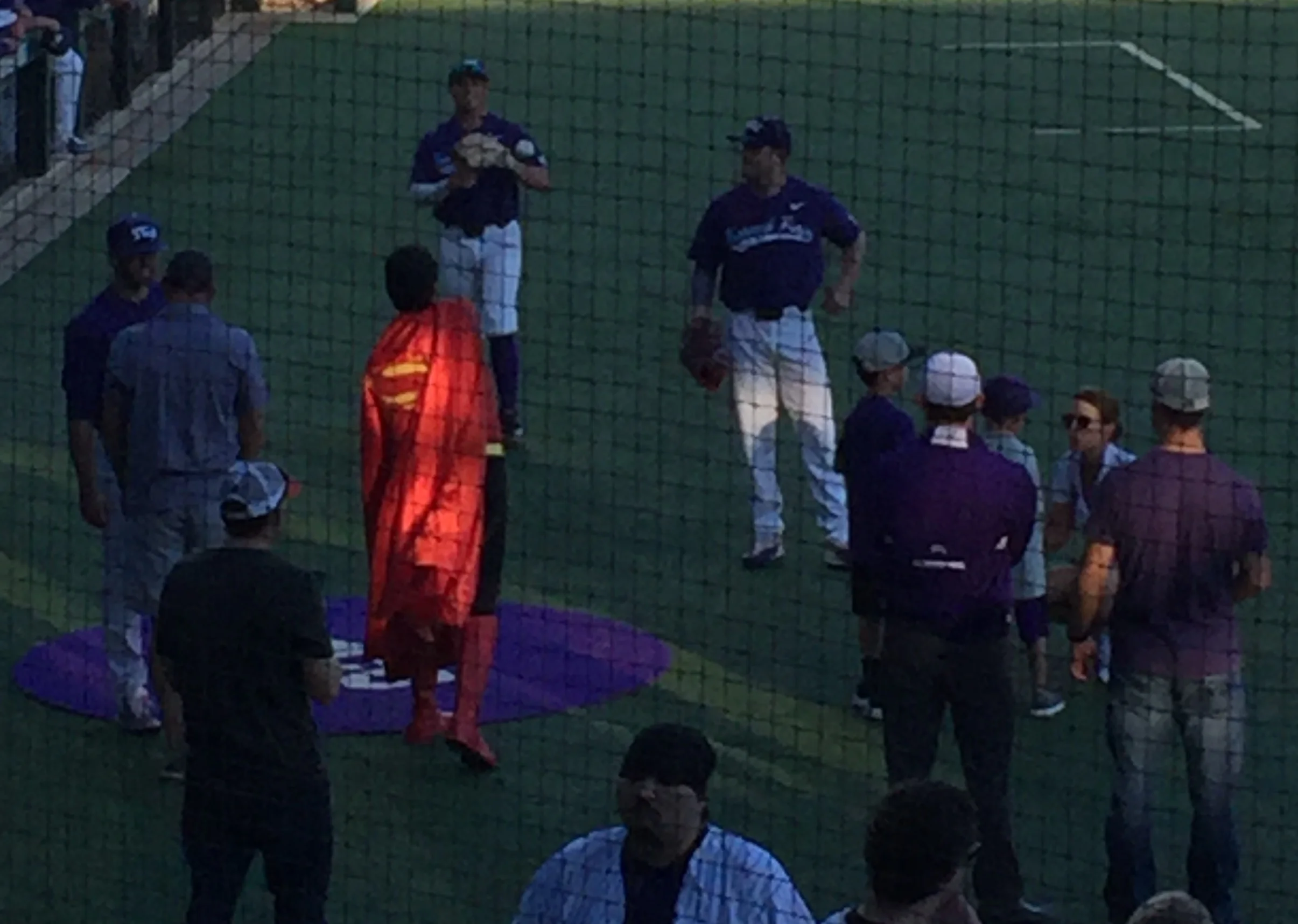 Even Superman knows the importance of warming up before the first pitch.