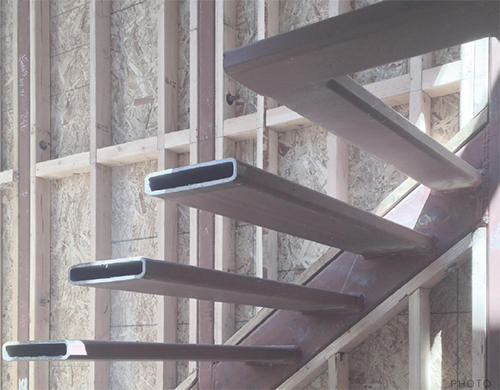 The client saw the pattern of the steel treads and wanted them to be visible in the final design. The stair panels and rails, which had been designed in steel, were changed back to glass as per the initial design. Image: Mark English Architects